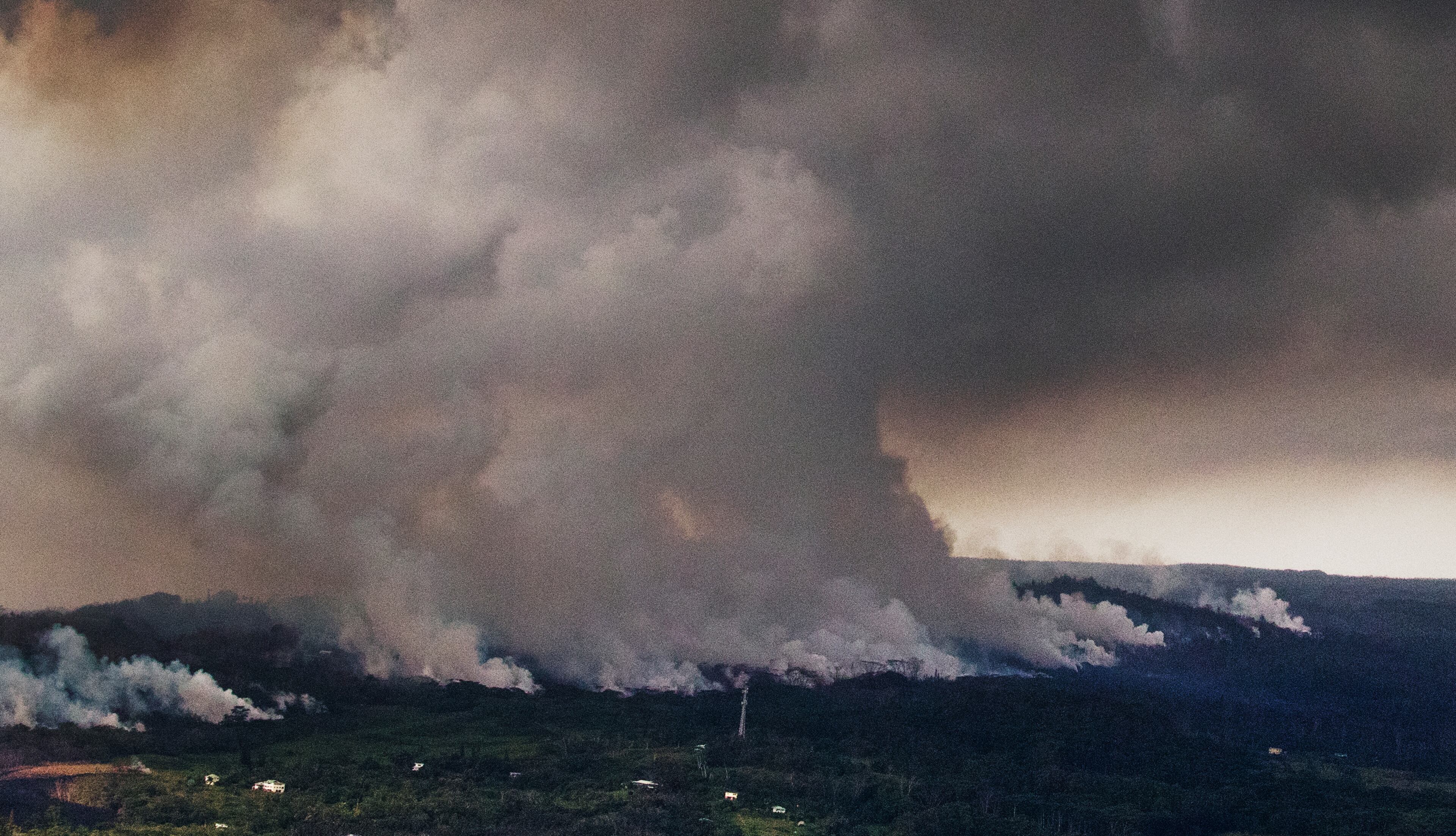 A plume of volcanic steam rises from the alignment of fissures in Hawaii's Kilauea East Rift zone, Wednesday, May 16, 2018. Earthquakes were damaging roads and buildings on Hawaii's Big Island on Wednesday as ash emissions streamed from Kilauea volcano. (Cindy Ellen Russell/Honolulu Star-Advertiser via AP)