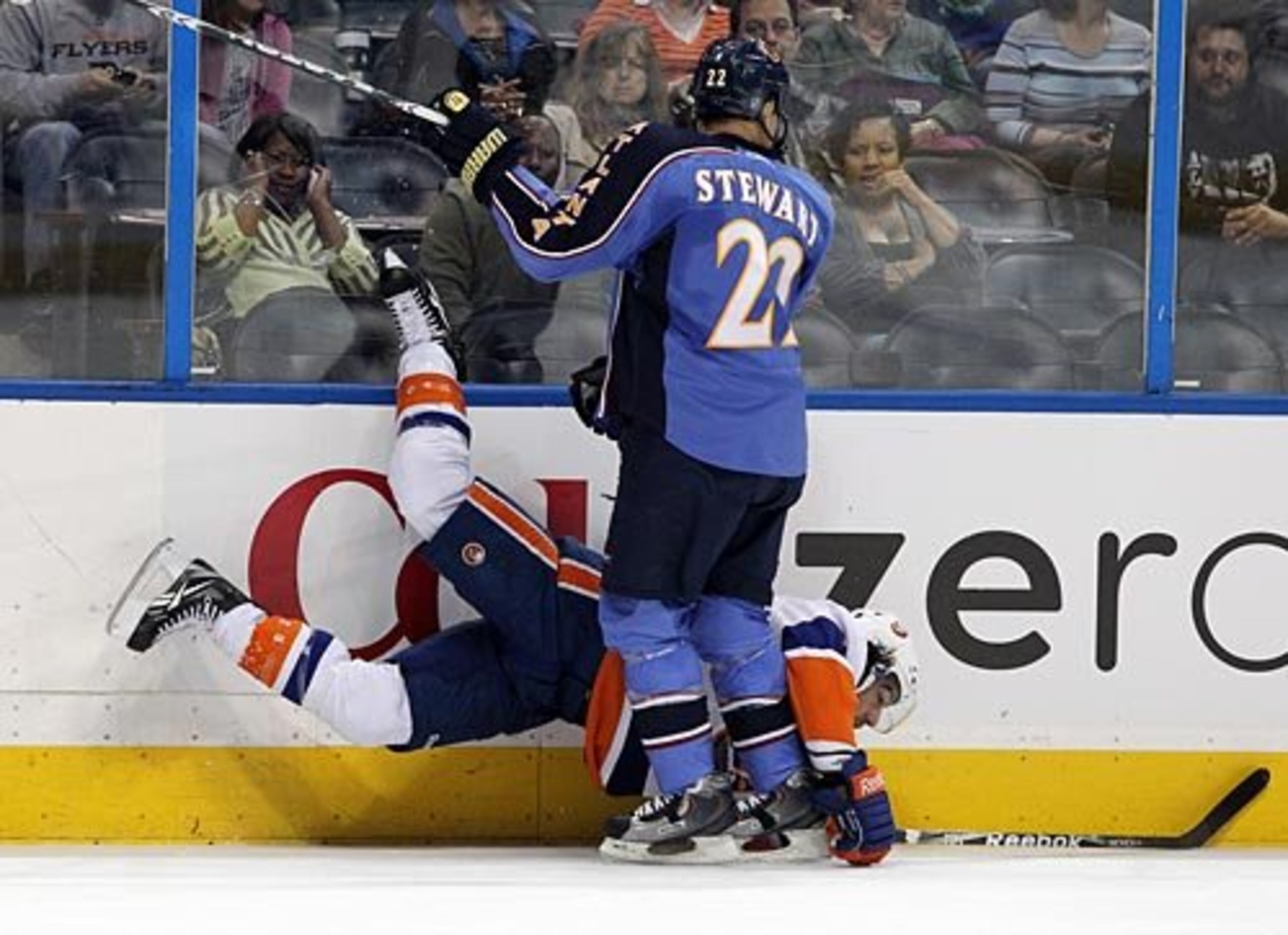 The Thrashers' Anthony Stewart takes the Islanders' Matt Moulson into the boards during 1st period action at Philips Arena in Atlanta on Sunday, Nov. 21, 2010.