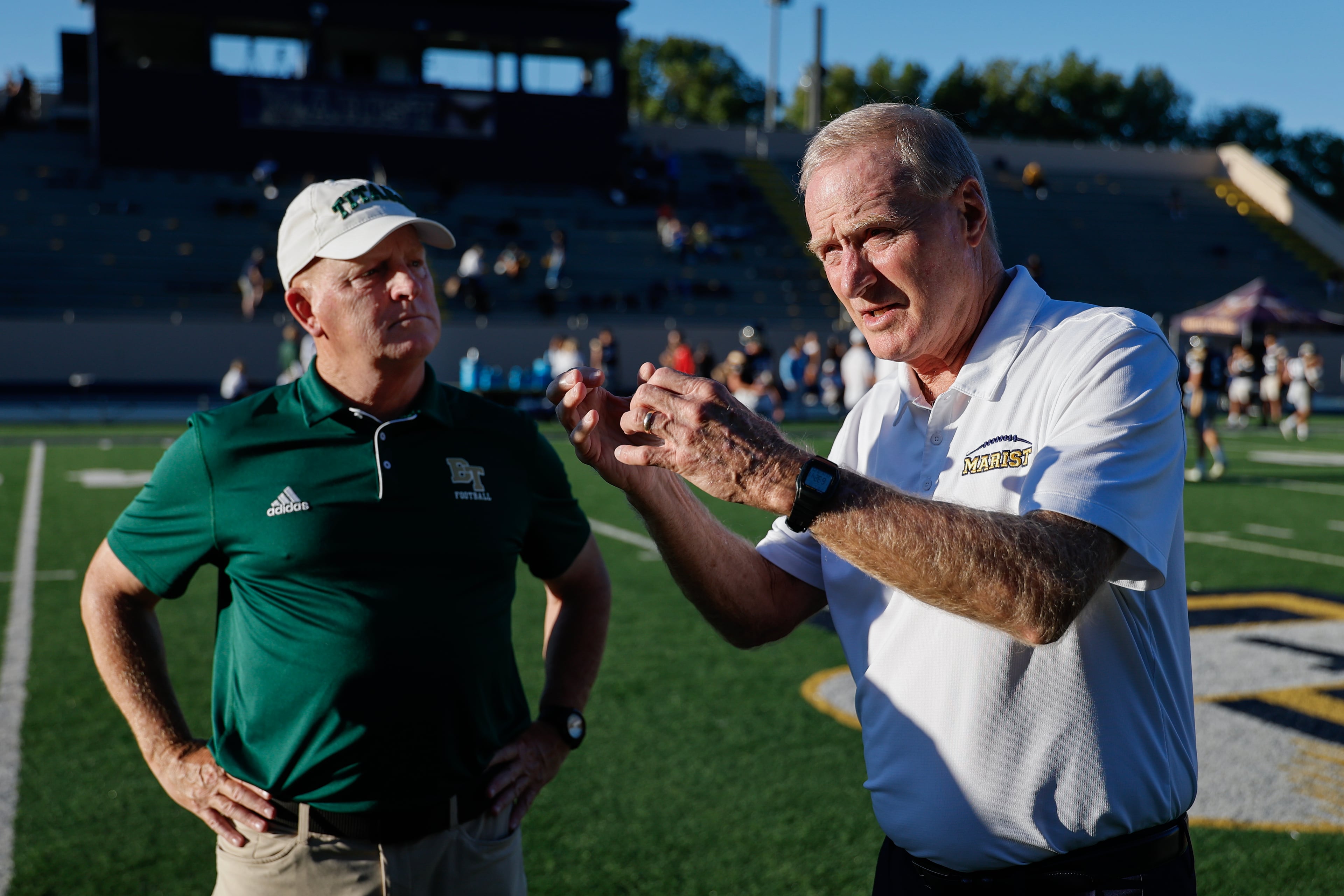 Blessed Trinity coach Ed Dudley (left) catches up with Marist coach Alan Chadwick before their game on Friday, Sept. 25, 2026, in Atlanta. (Erik S. Lesser for the AJC)