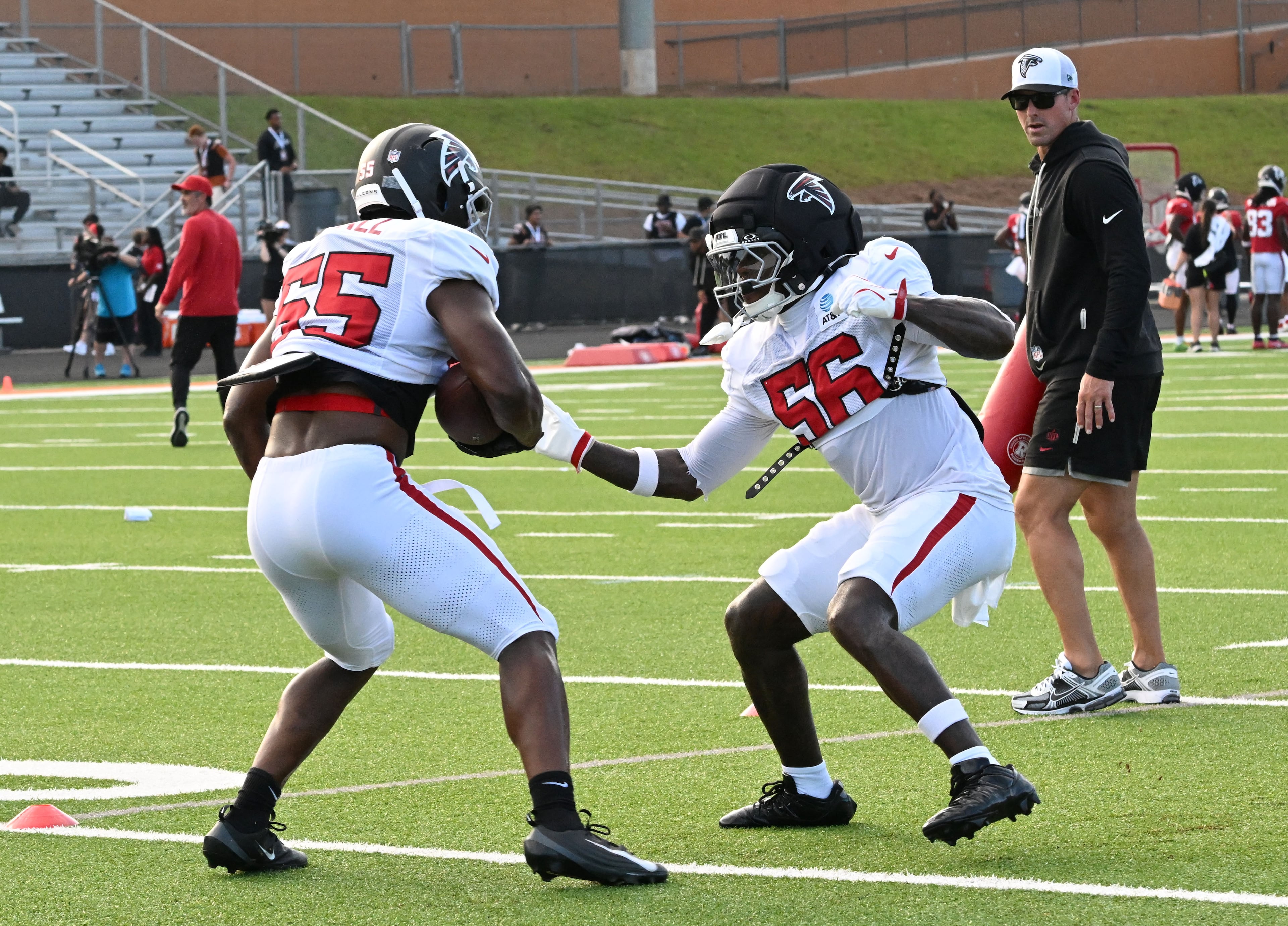 The Falcons' Harold Perkins Jr. (right) and Channing Tindall run a drill during "Saturday Night Lights" practice Saturday, Aug. 8, 2026, at Lanier High School in Sugar Hill. (Hyosub Shin/AJC)