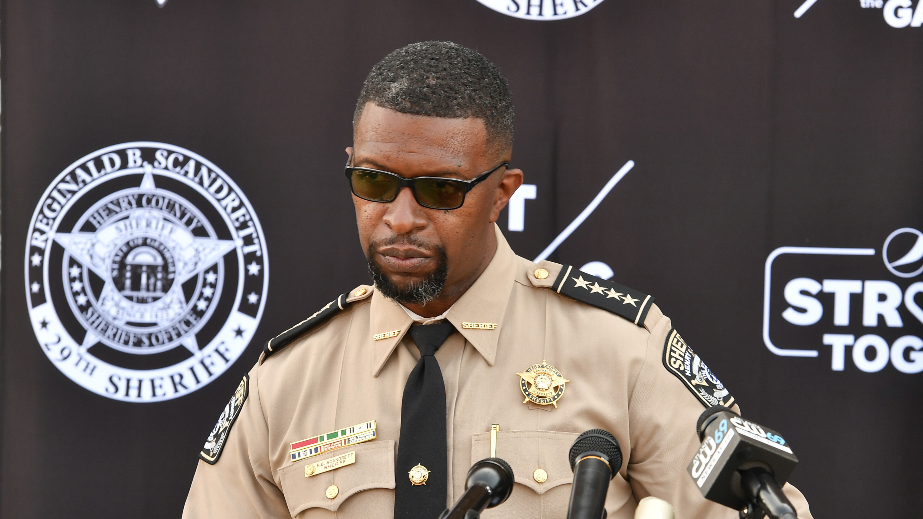 Henry County Sheriff Reginald Scandrett announces de-escalation training for 1,000 Henry and Fulton County deputies.