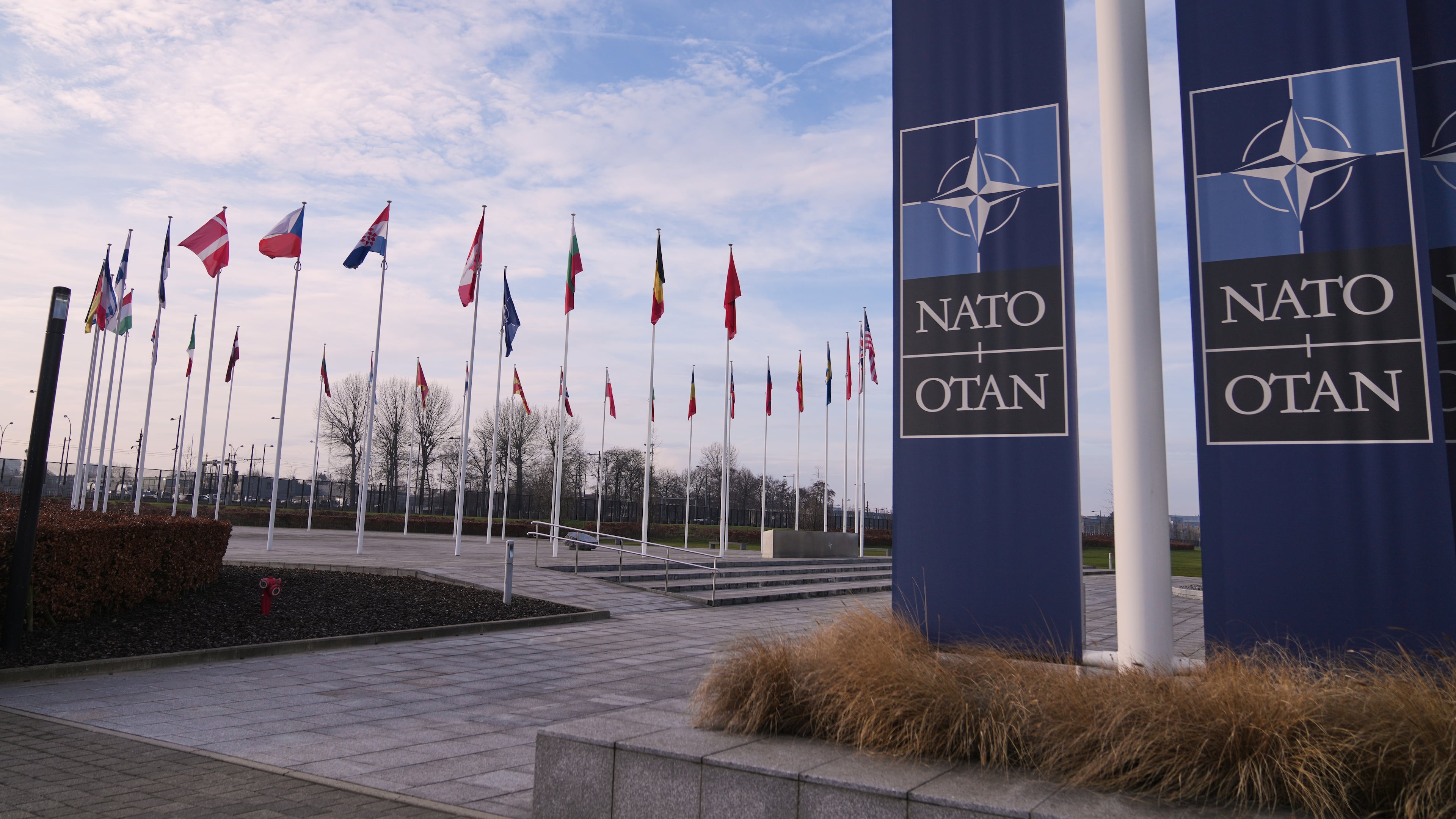 FILE - Flags flap in the wind outside NATO headquarters in Brussels, Jan. 19, 2026. (AP Photo/Virginia Mayo, File)