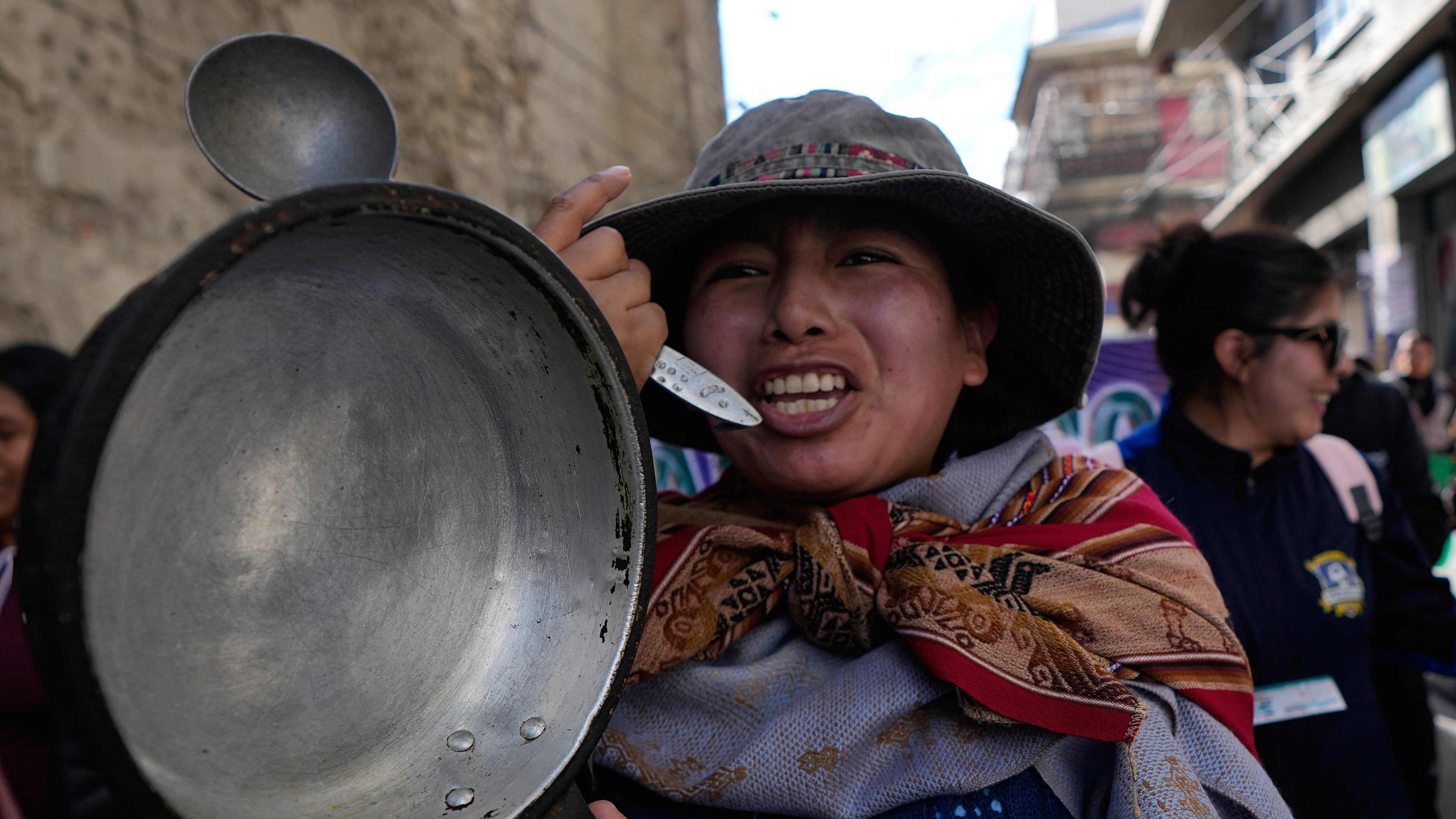 A teacher holds an empty pot during an anti-government protest in La Paz, Bolivia, Tuesday, Sept. 15, 2026. (AP Photo/Juan Karita)