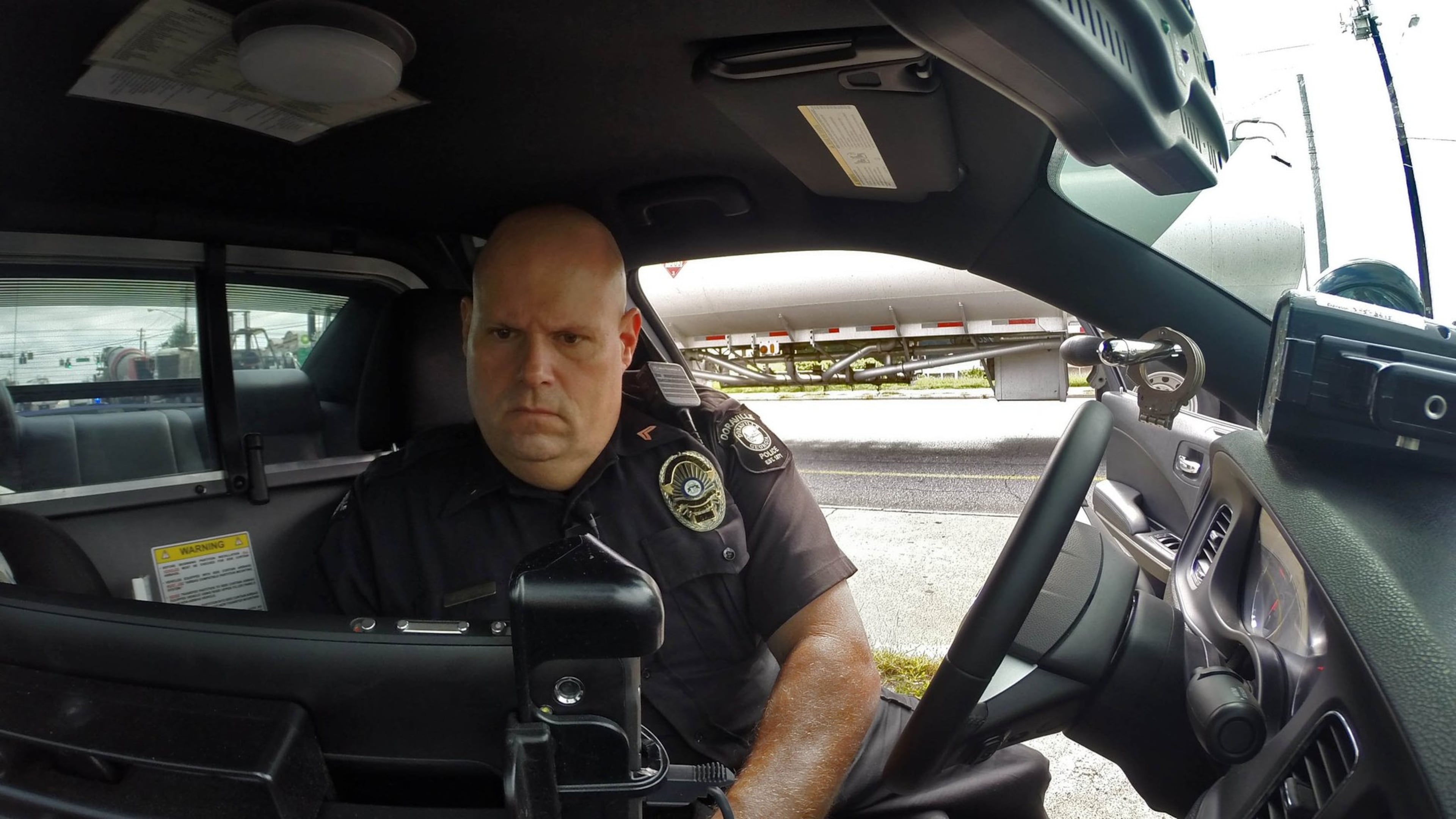 Cpl. John Lowe of the Doraville police department writes a speeding ticket for a driver he clocked at 51 mph in a 35 zone. On a per capita basis, Doraville generates the highest revenue from traffic tickets of any jurisdiction in metro Atlanta.