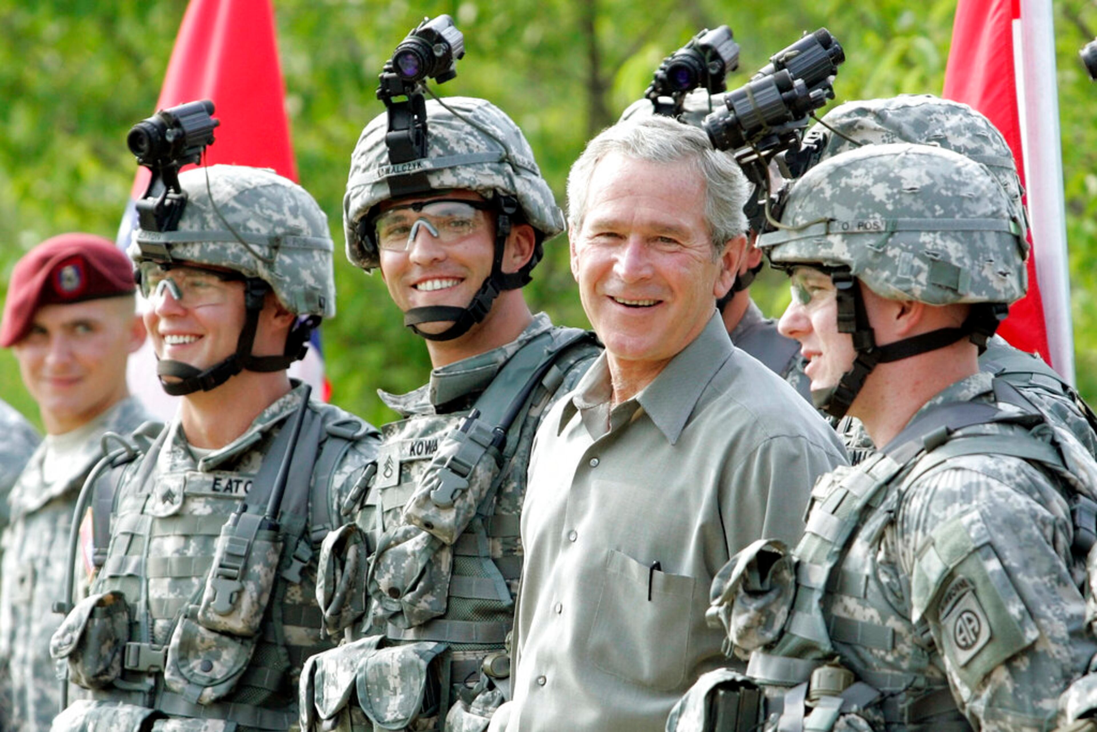 FILE - In this July 4, 2006 file photo, President Bush smiles as he poses for a group photo with military personnel during his visit to U.S. Army Special Operations Command at Fort Bragg, N.C. (AP Photo/Pablo Martinez Monsivais)