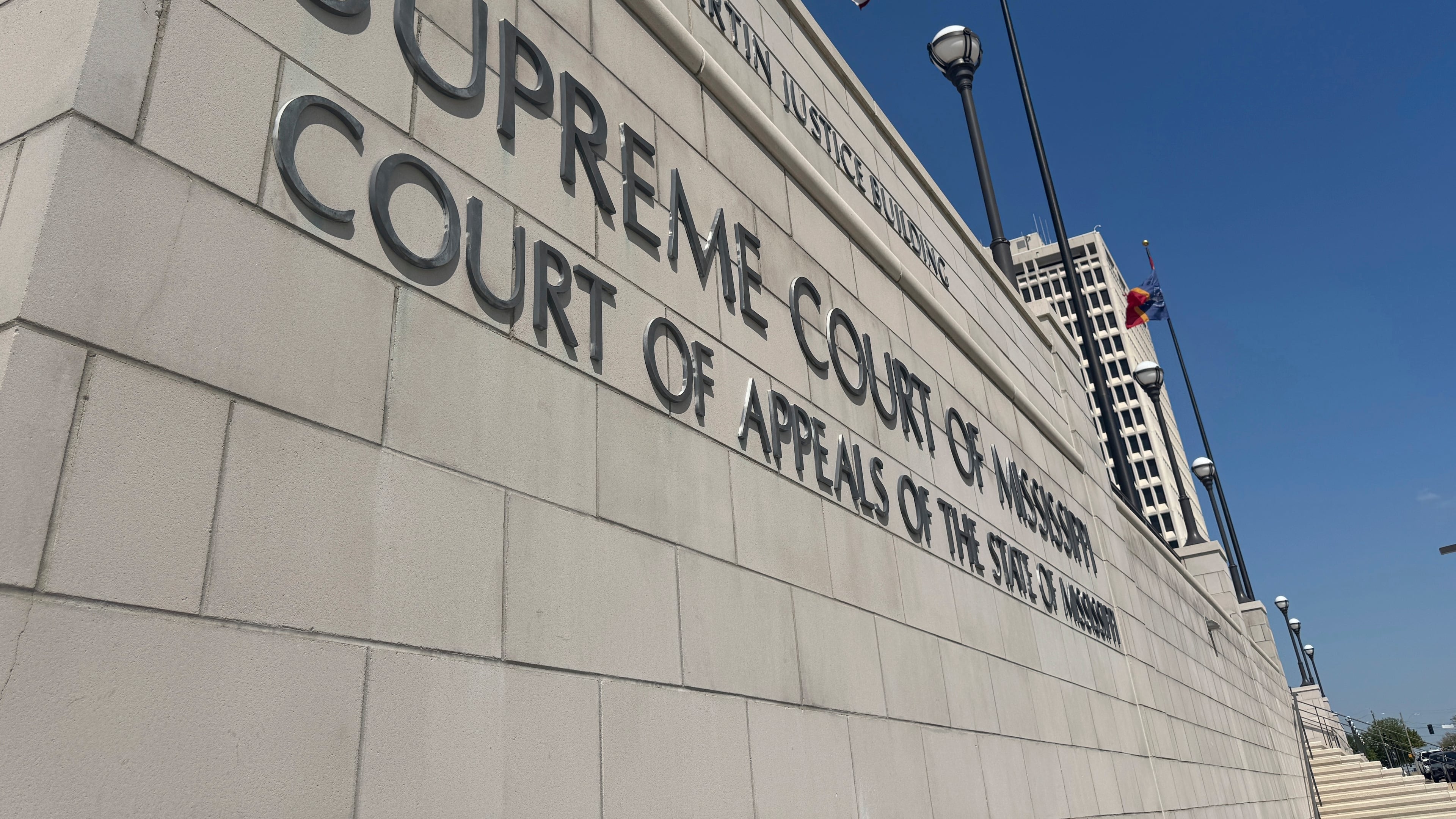 FILE - The American flag waves outside the Mississippi Supreme Court in Jackson, Miss., April 17, 2025. (AP Photo/Sophie Bates, File)