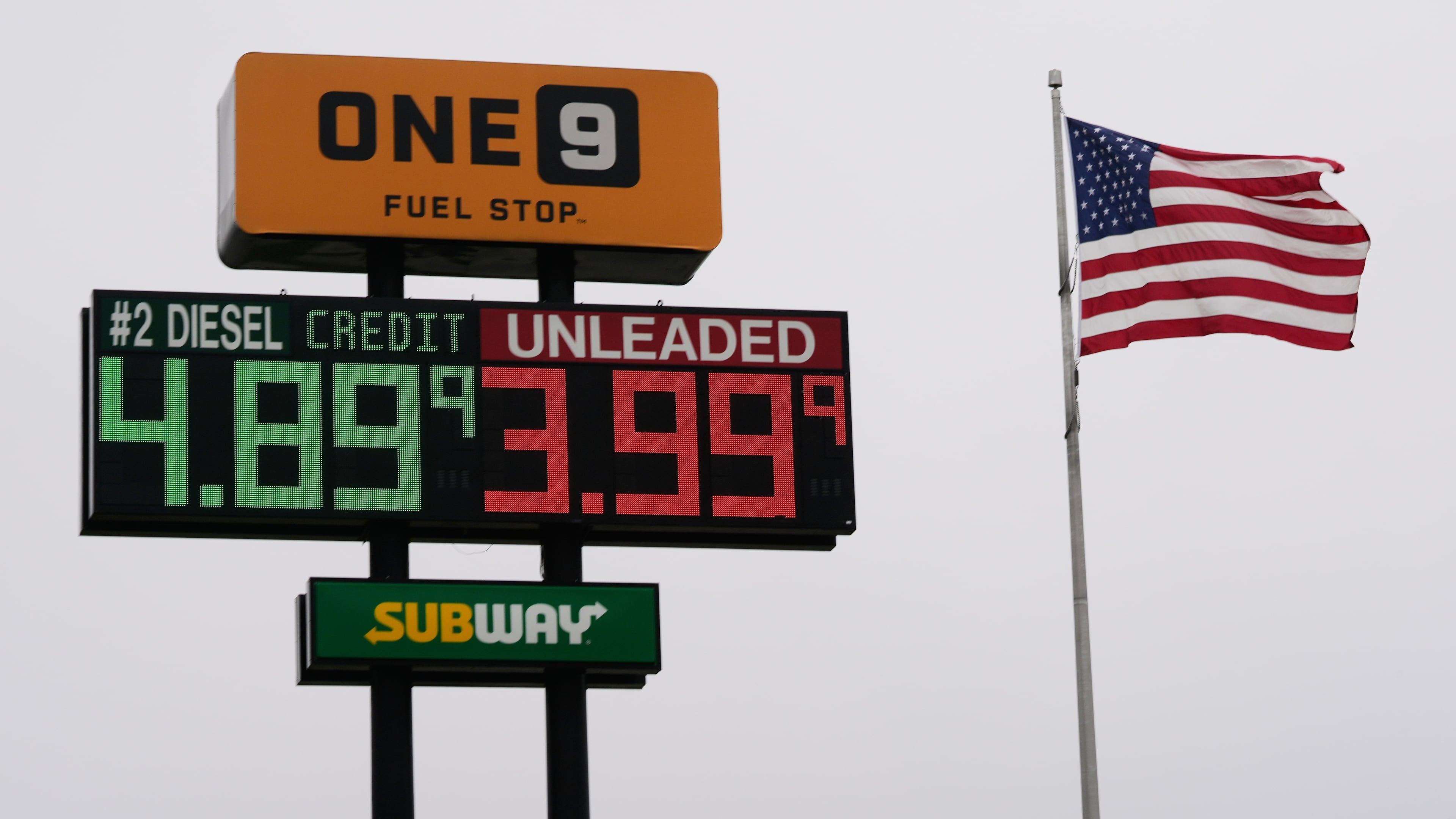 The American Flag flies next to a One9 Fuel Stop sign displaying gas prices for diesel and unleaded gas in Wilmington, Ohio, Wednesday, June 10, 2026. (AP Photo/Carolyn Kaster)