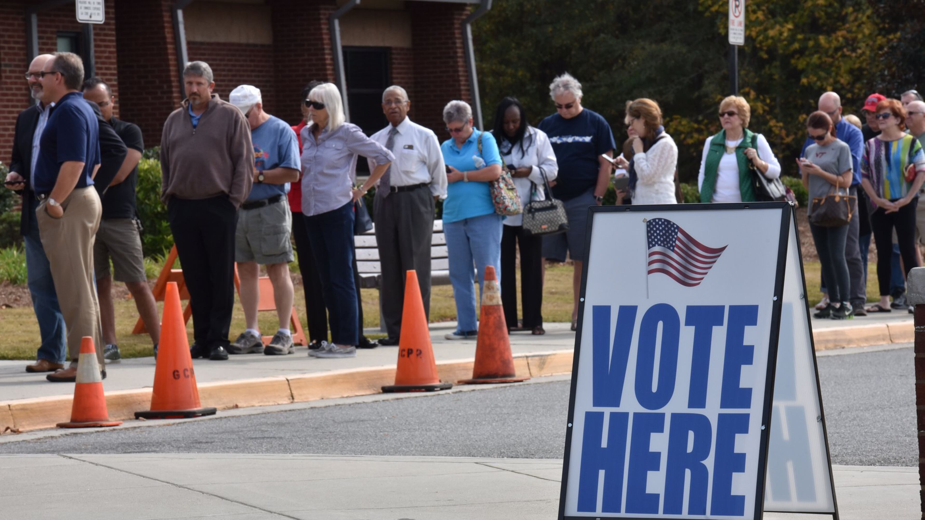 Early voters wait outside George Pierce Park Community Recreation Center in Suwanee on Wednesday, Oct. 26, 2016. HYOSUB SHIN / HSHIN@AJC.COM