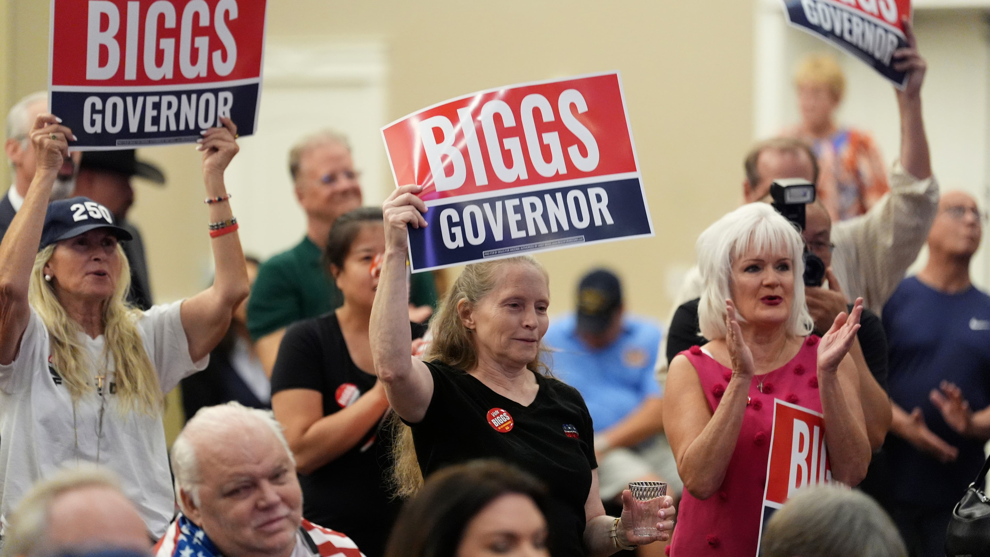 Supporters of Rep. Andy Biggs, R-Ariz., who is running in the primary for Arizona governor, listen to speakers at a campaign event, Friday, July 17, 2026, in Gilbert, Ariz. (AP Photo/Ross D. Franklin)