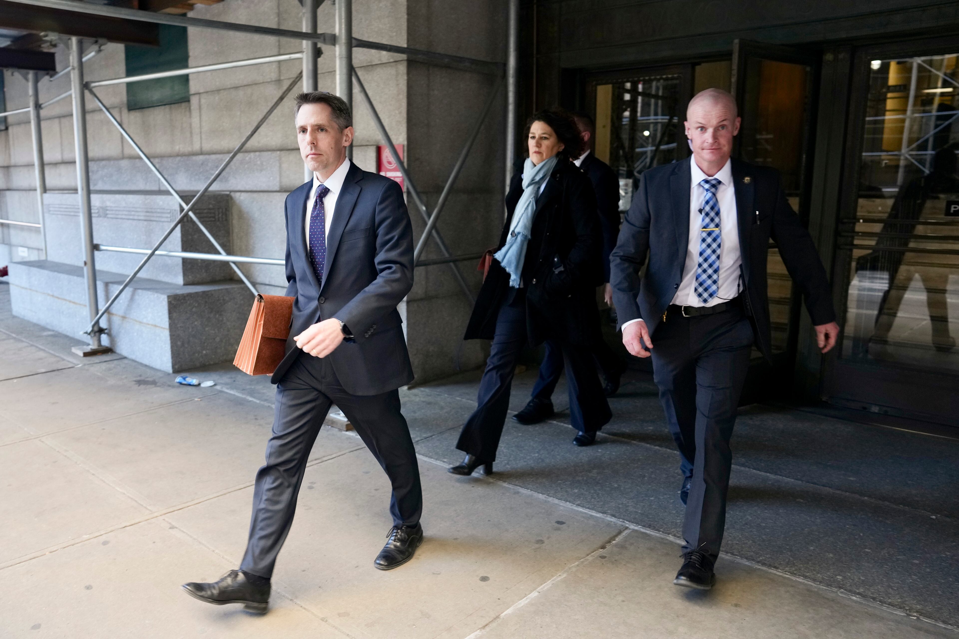 Matthew Colangelo, left, and Susan Hoffinger, second from left, prosecutors with the Manhattan district attorney's office, in Manhattan, March 30, 2023. A Manhattan grand jury voted to indict Donald J. Trump on Thursday for his role in paying hush money to a porn star, according to four people with knowledge of the matter. (Todd Heisler/The New York Times)