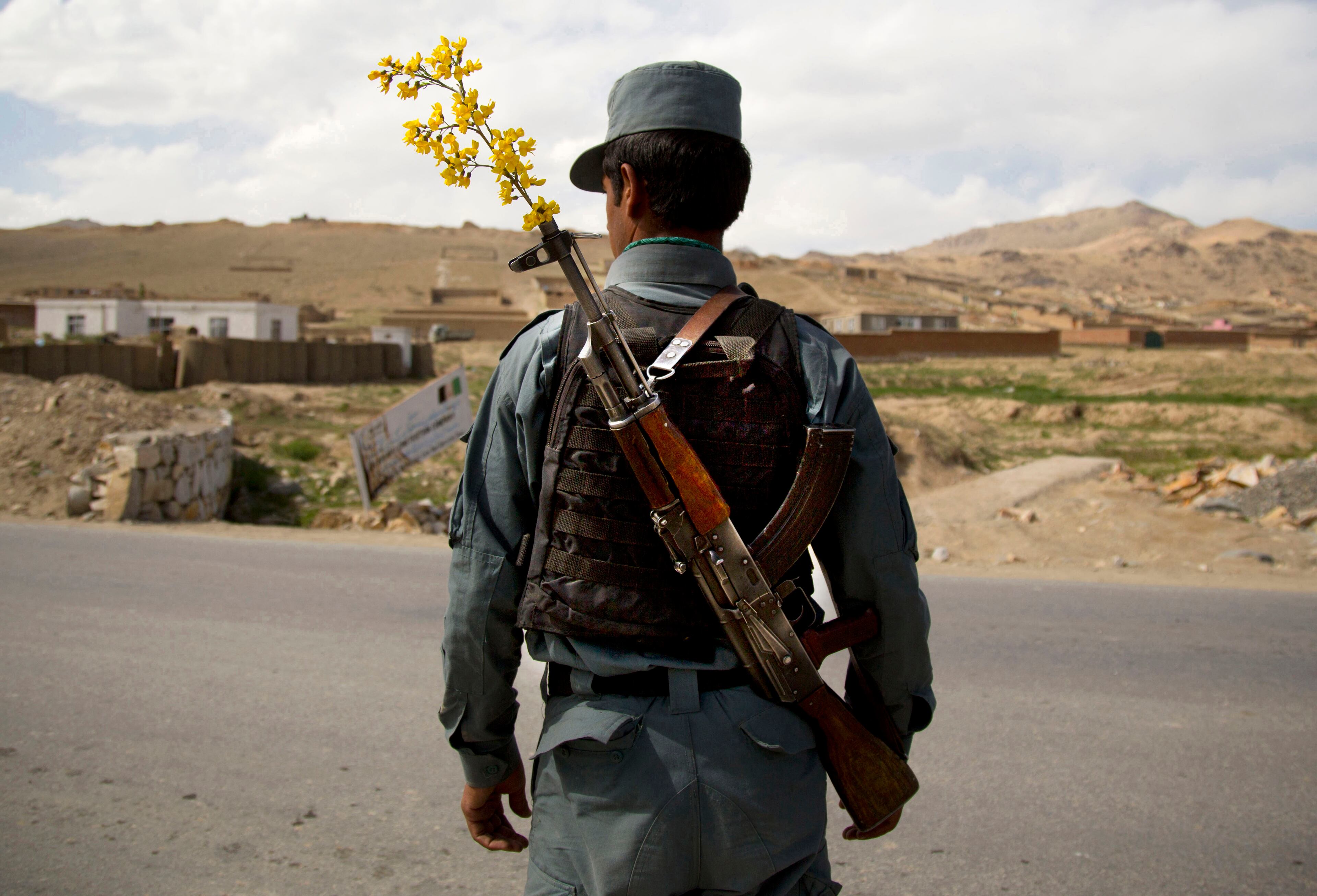 In this Wednesday, May 15, 2013 file photo made by Associated Press photographer Anja Niedringhaus, an Afghan National Police officer mans a checkpoint in the outskirts of Maidan Shahr, Wardak province, Afghanistan. Niedringhaus, 48, an internationally acclaimed German photographer, was killed and an AP reporter was wounded on Friday, April 4, 2014 when an Afghan policeman opened fire while they were sitting in their car in eastern Afghanistan. (AP Photo/Anja Niedringhaus, File)