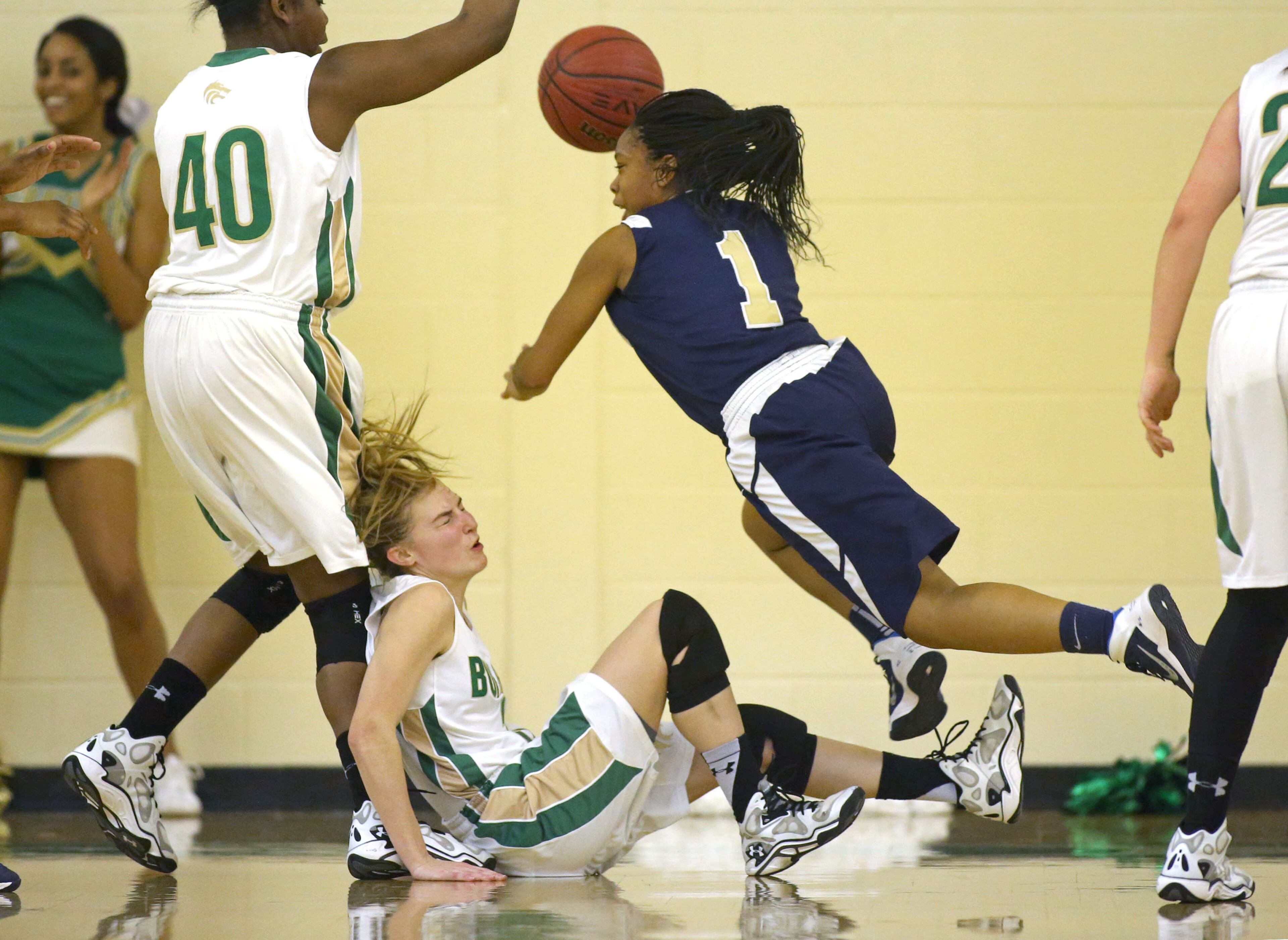 Buford's Tara Dambach (3) hits the floor as she gets a charge from Decatur's Jayla Morrow (1) in their game Monday night in Buford, Ga JASON GETZ / SPECIAL