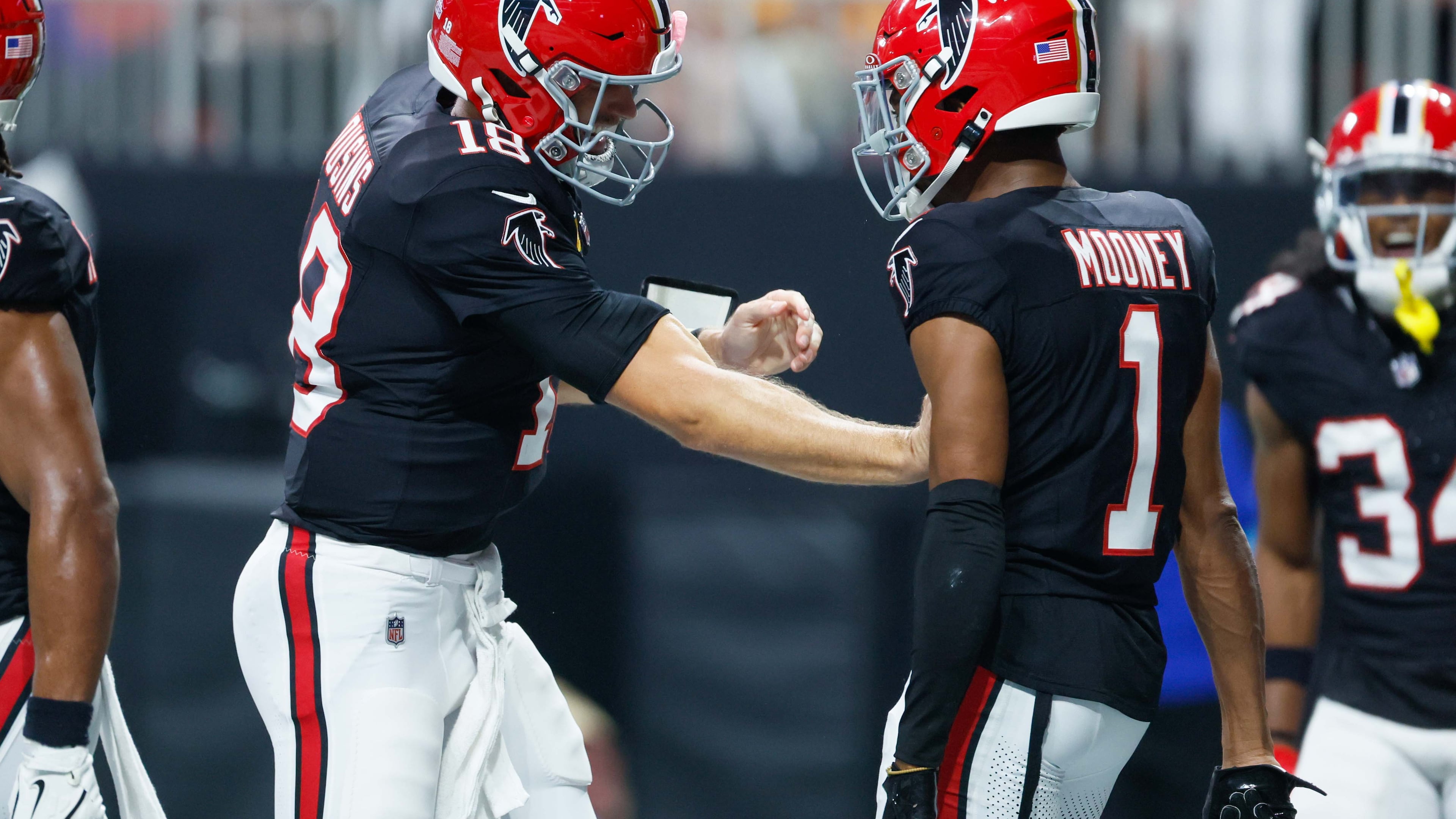 Atlanta Falcons wide receiver Darnell Mooney (1) celebrates with quarterback Kirk Cousins (18) after his touchdown during the first half of a game last year against the Tampa Bay Buccaneers at Mercedes-Benz Stadium in Atlanta.
(Miguel Martinez/ AJC)