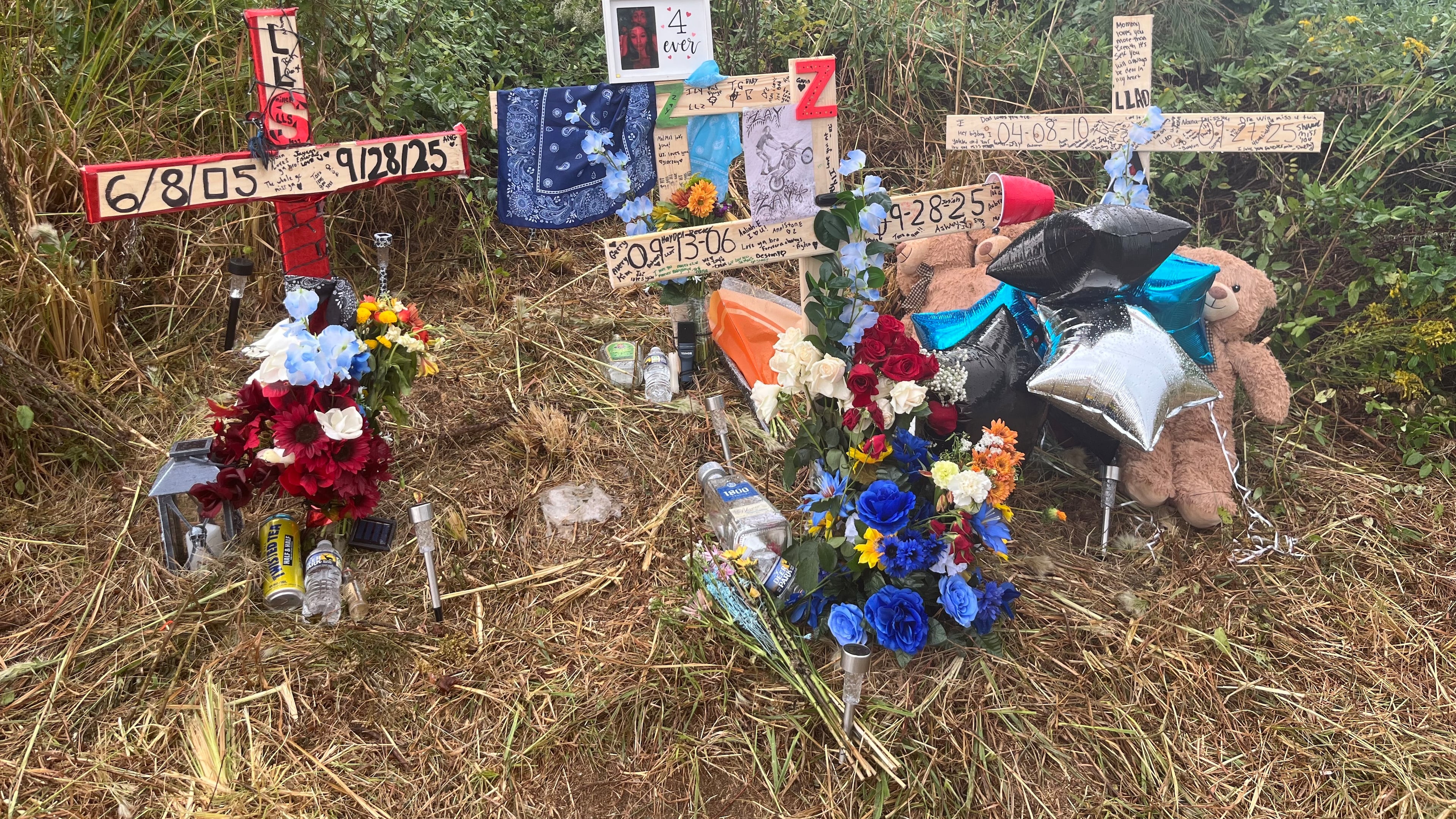 The families of the four young men who died in a car wreck in Cartersville over the weekend set up a memorial for them at the intersection of Ga. 20 and Cline Smith Road in Cartersville. (Alexis Stevens/AJC)