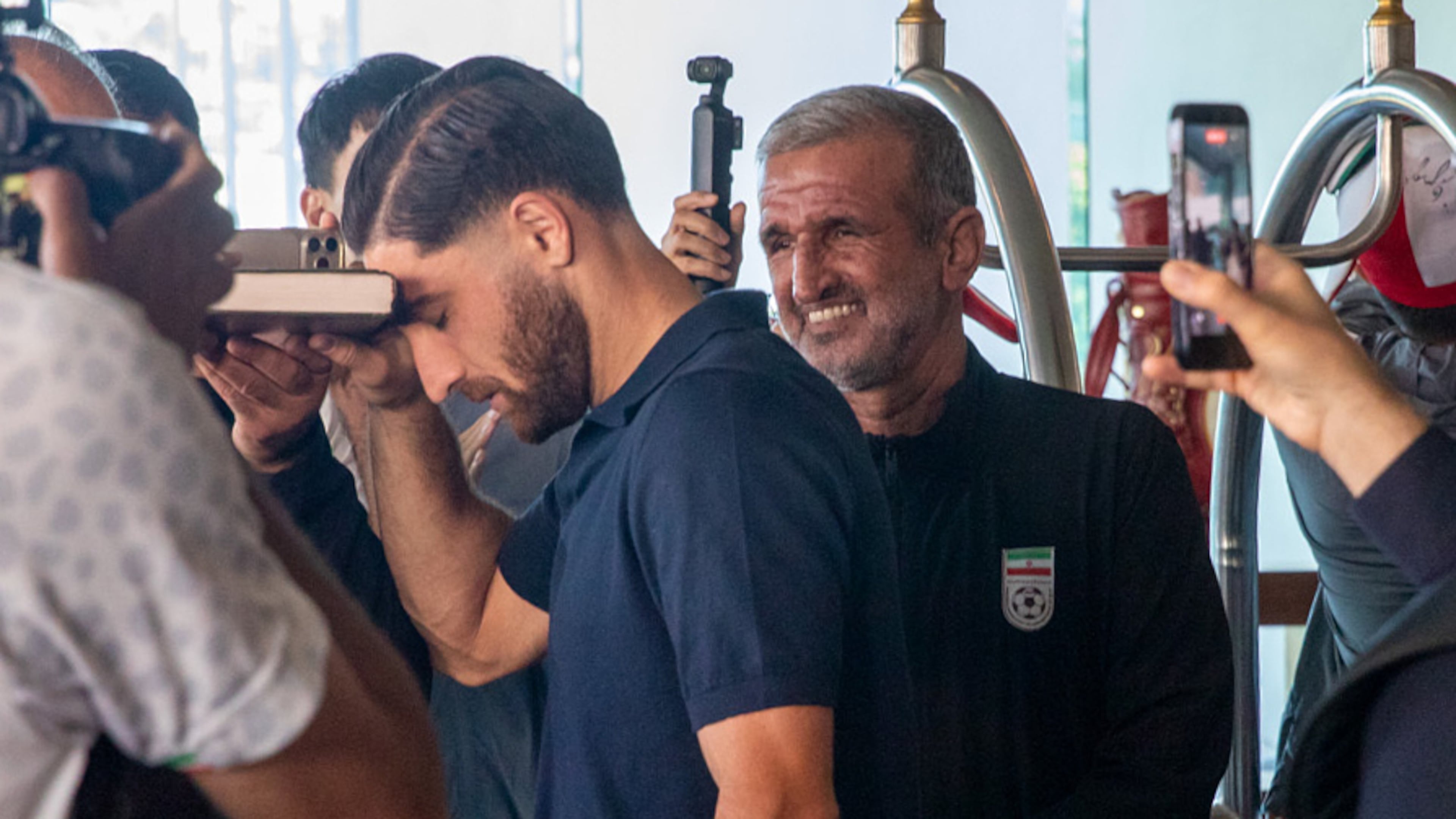 Iran national soccer team member Alireza Jahanbakhsh touches his forehead to the Quran as he departs from the Tijuana Marriott in Tijuana, Mexico on Saturday June 20, 2026. (AP Photo/Gabriela Aoun Angueira)