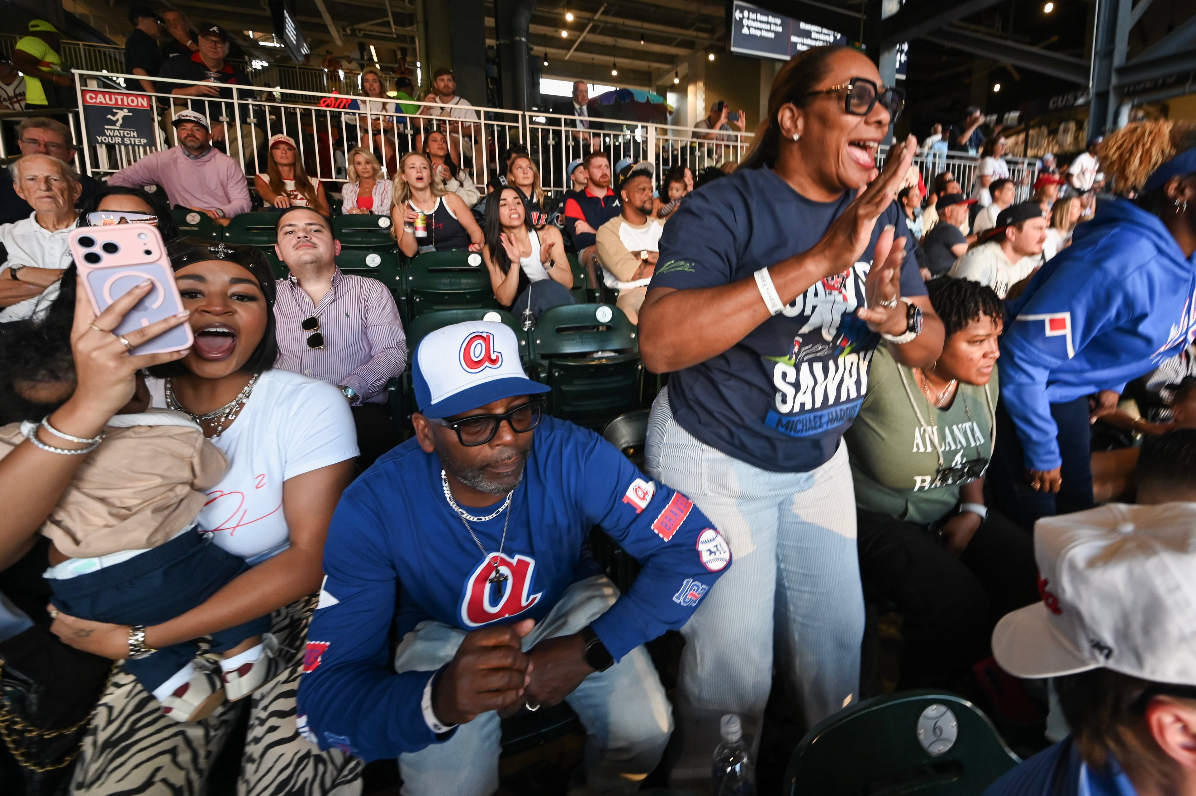Michael and LaTaucha Harris watch their son Atlanta Braves center fielder Michael Harris II single on a bunt during the second inning of Game 3 of the MLB National League Division Series between the Atlanta Braves and the Los Angeles Dodgers, Tuesday, Oct. 6, 2026, in Atlanta. (Hyosub Shin/AJC)