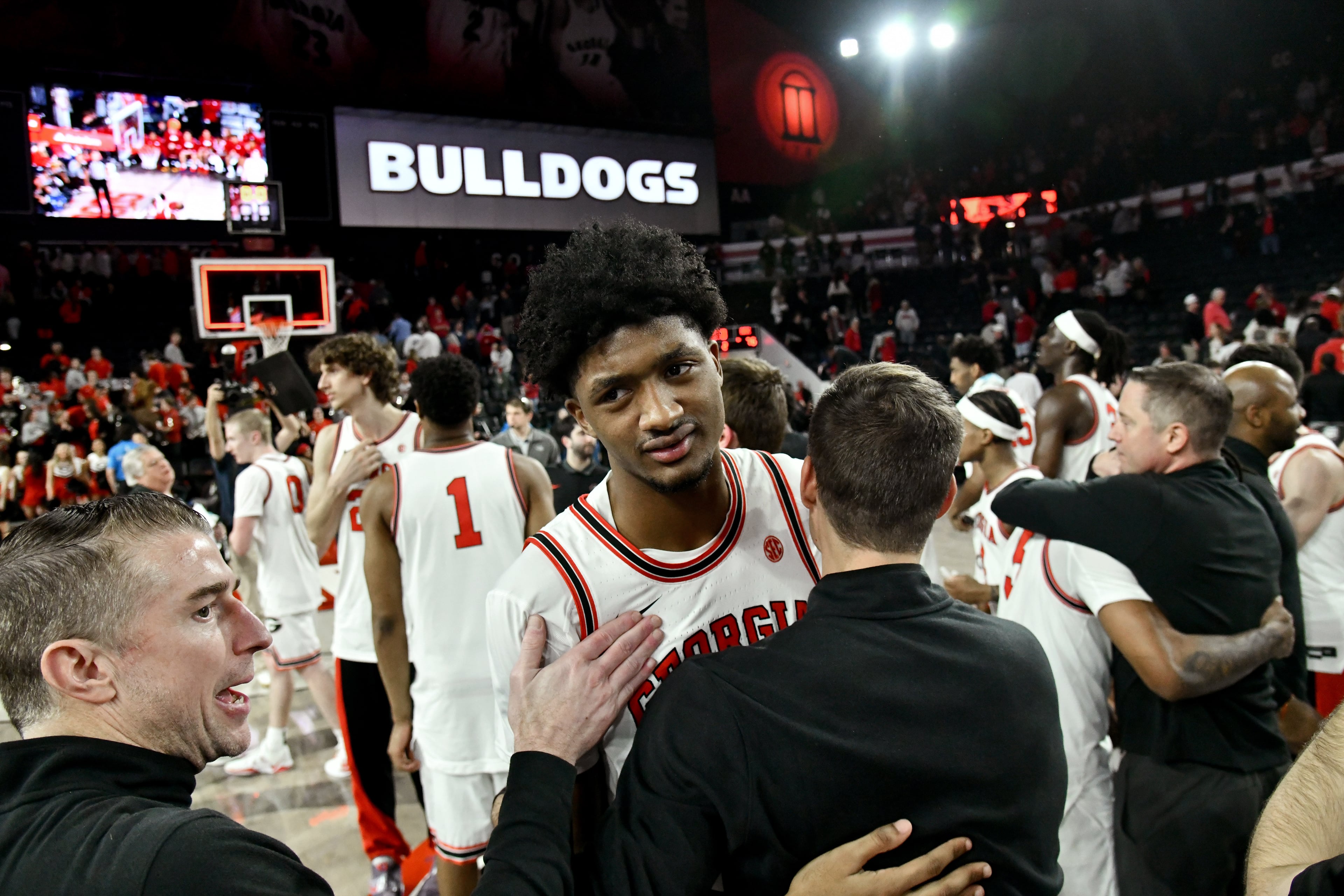 Georgia forward Jake Wilkins celebrates with coaching staff after Georgia beat Arkansas in an NCAA college basketball game at Stegeman Coliseum, Saturday, Jan. 17, 2026, in Athens. Georgia won 90-76 over Arkansas. (Hyosub Shin/AJC)