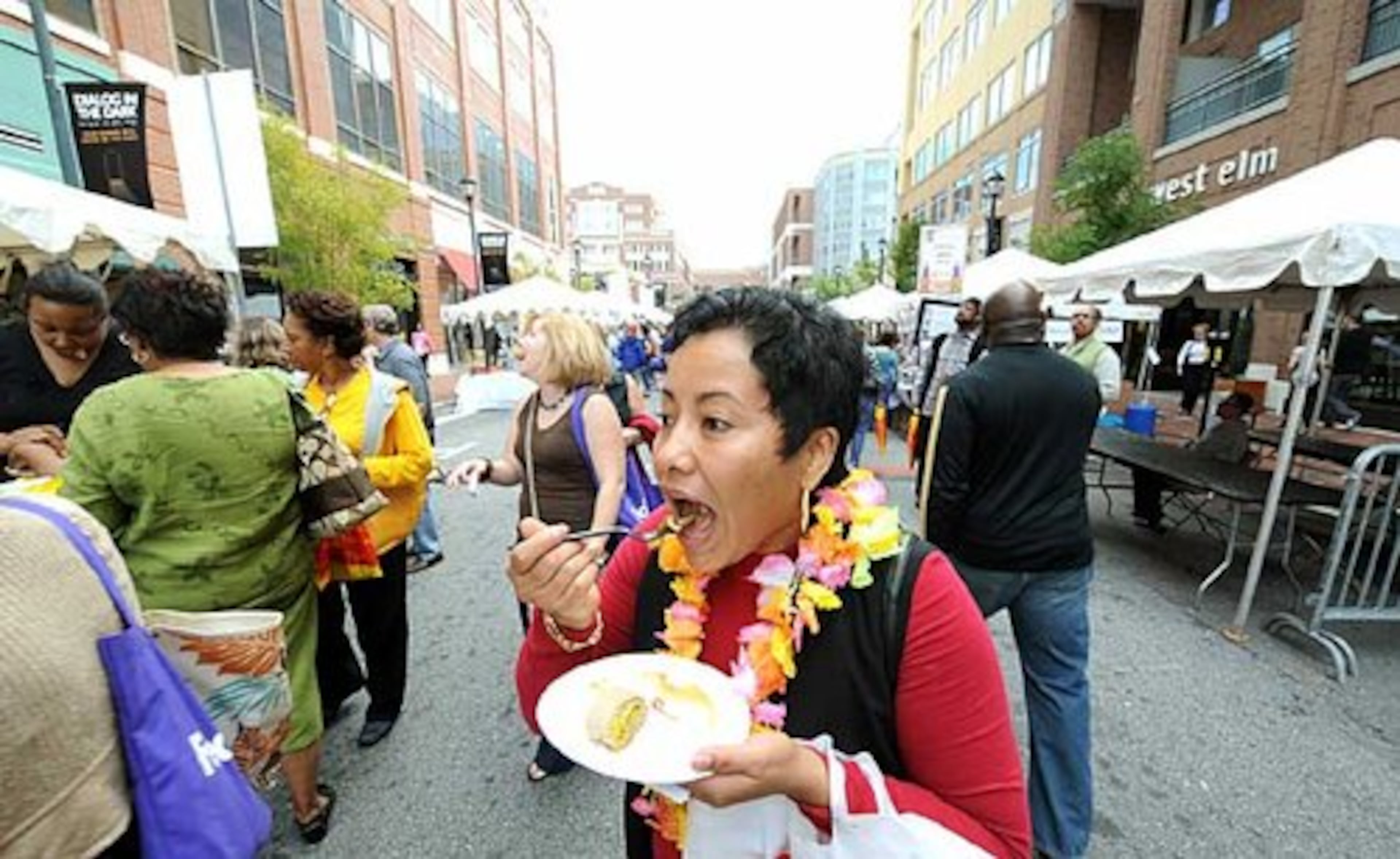 Magdalena Ash of Gainesville, Ga., enjoys a dish from Desta Ethiopian Kitchen during Taste of Atlanta.
