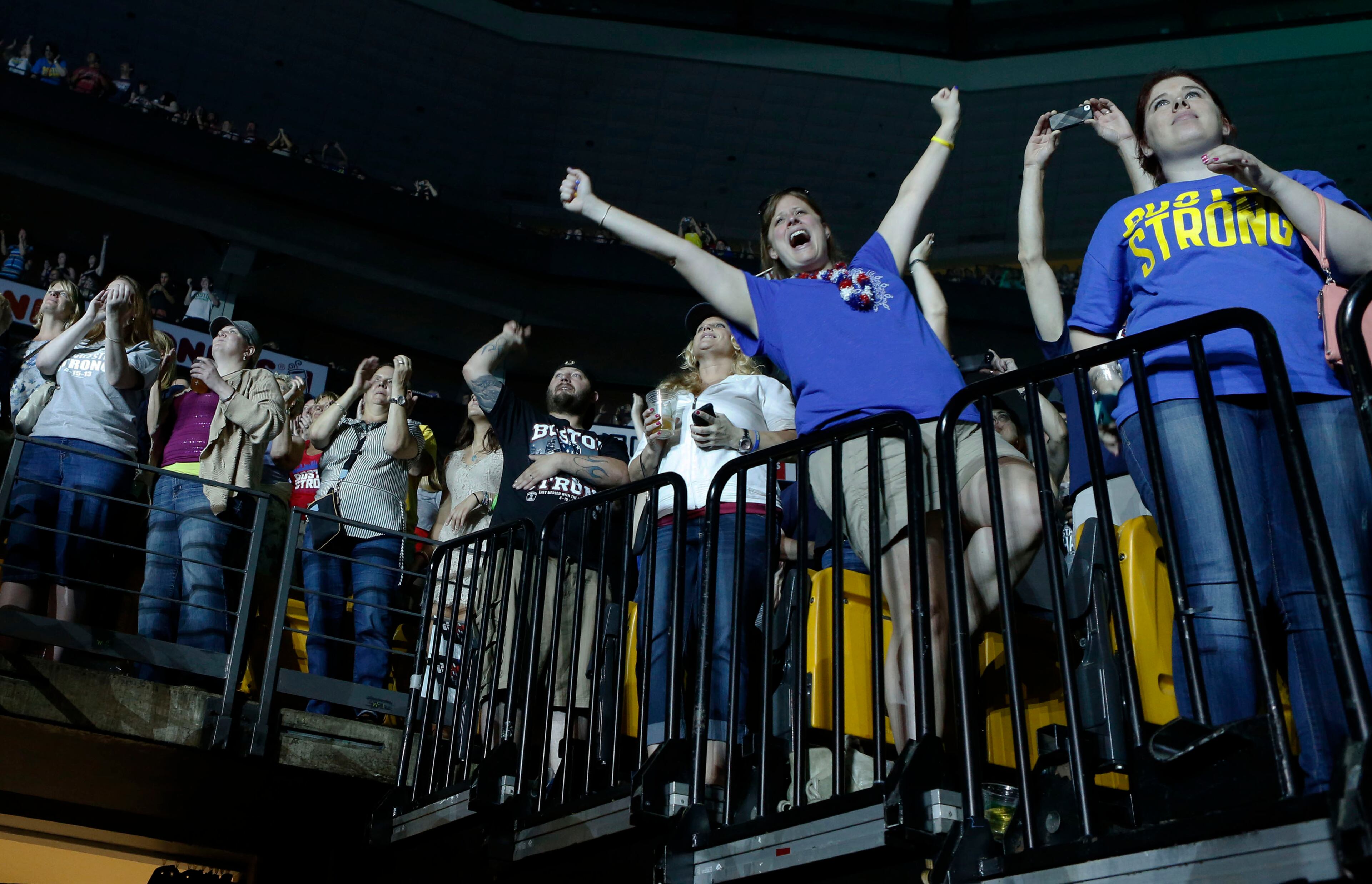 Concert goers react during the Boston Strong Concert: An Evening of Support and Celebration at the TD Garden on Thursday, May 30, 2013 in Boston. (Photo by Bizuayehu Tesfaye/Invision/AP)