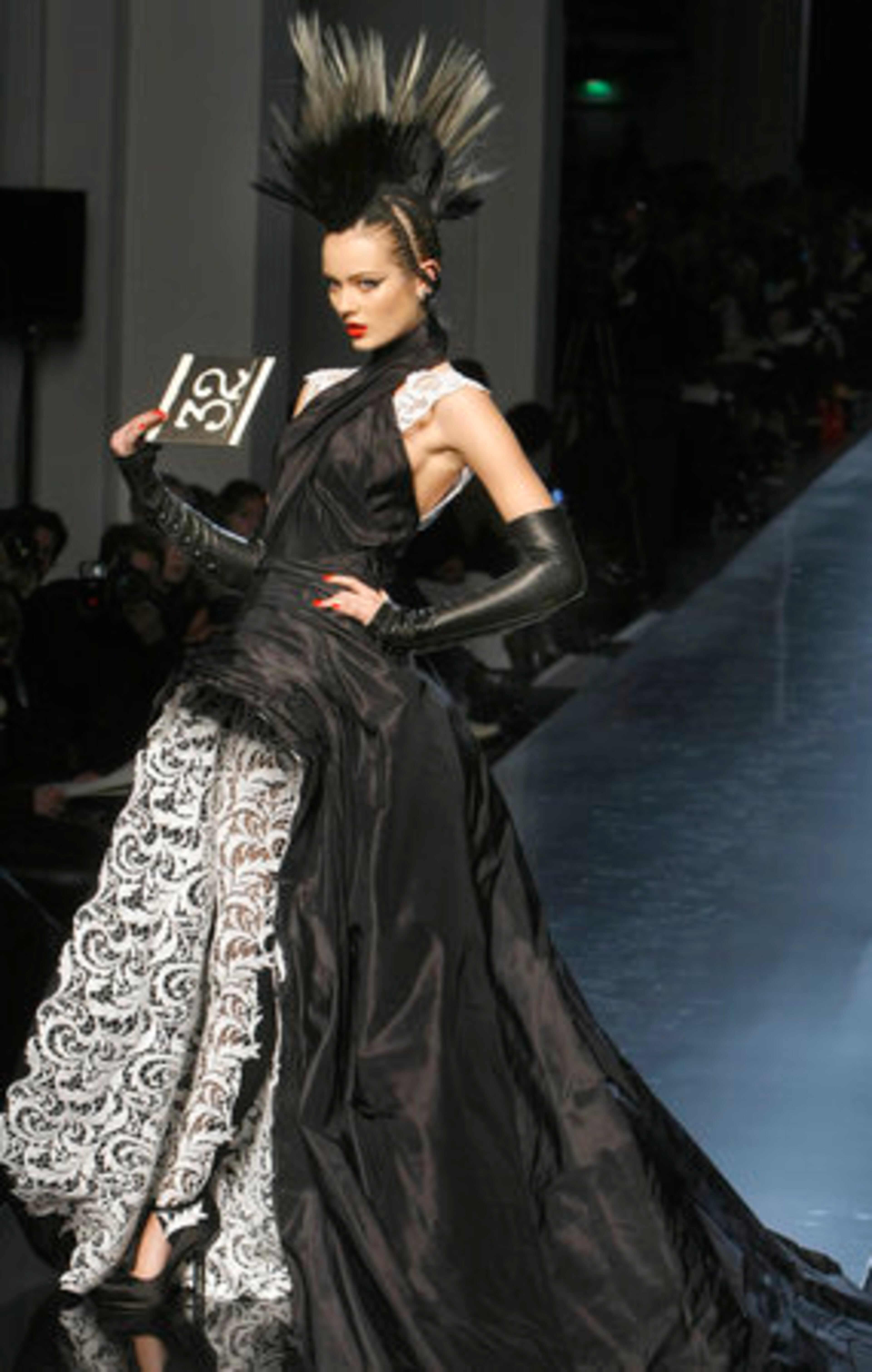 Yards of black silk cascaded over delicate white lace in look 32.