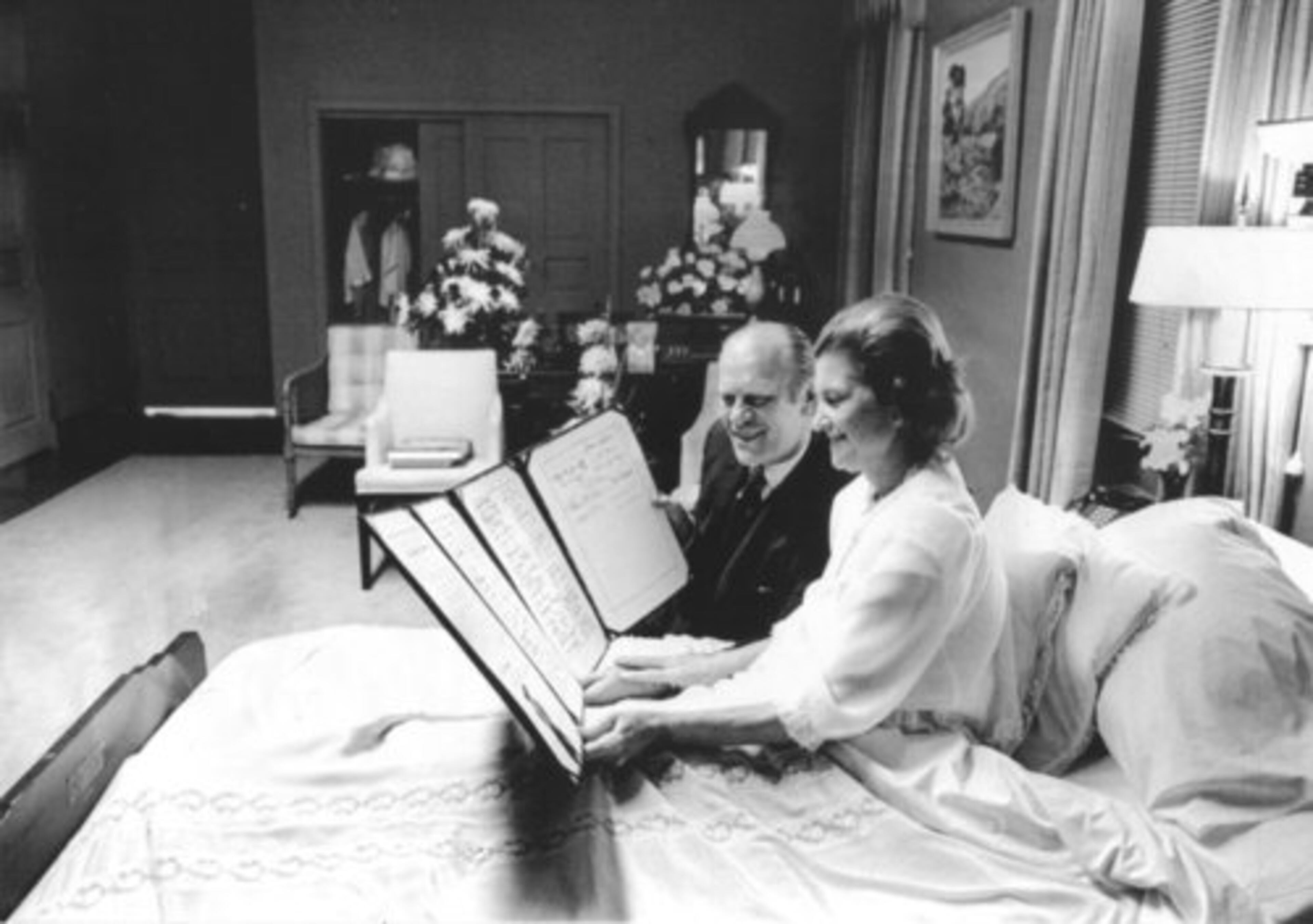 First lady Betty Ford and husband Gerald look at a petition of "support and best wishes" signed by all 100 U.S. Senators while Betty Ford recovered from cancer surgery at the Bethesda Naval Hospital.