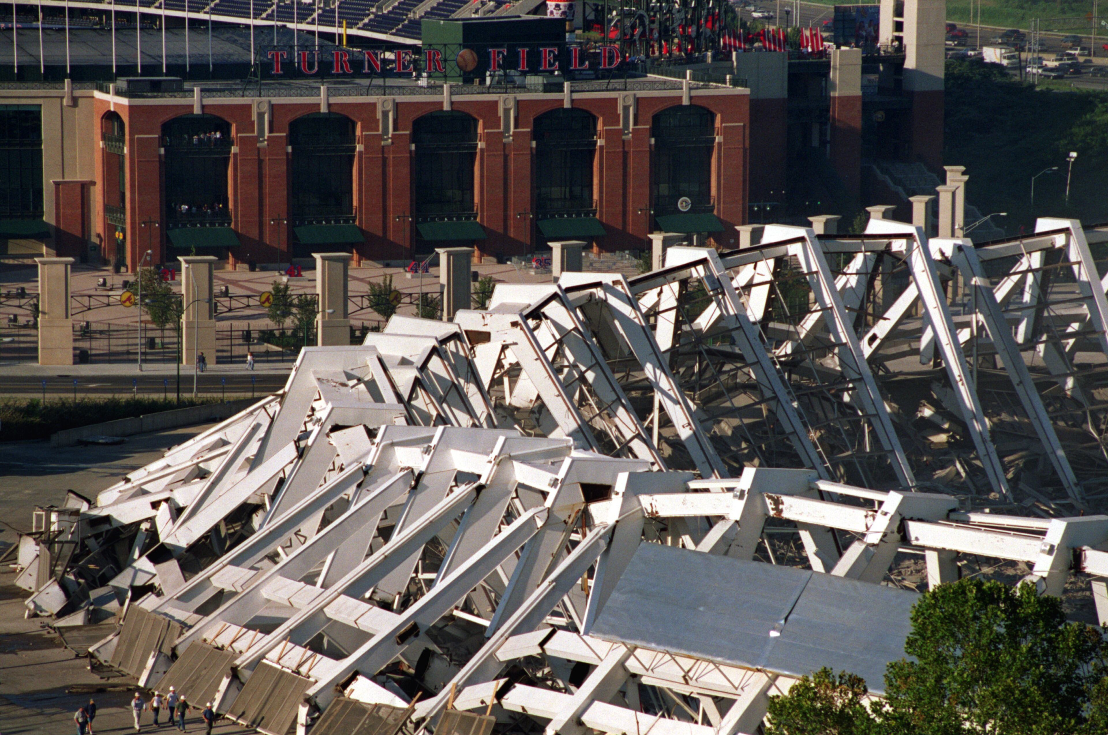 970802 - Atlanta, Georgia - Turner Field rises up behind the collapsed remains of Atlanta Fulton County Stadium after the implosion Saturday morning, 8/2/97. Demolition crews imploded it down with a series of 1,200 successive detonations. The space will be turned into 4,000 parking spaces. (AJC Staff Photo/Kevin Keister)