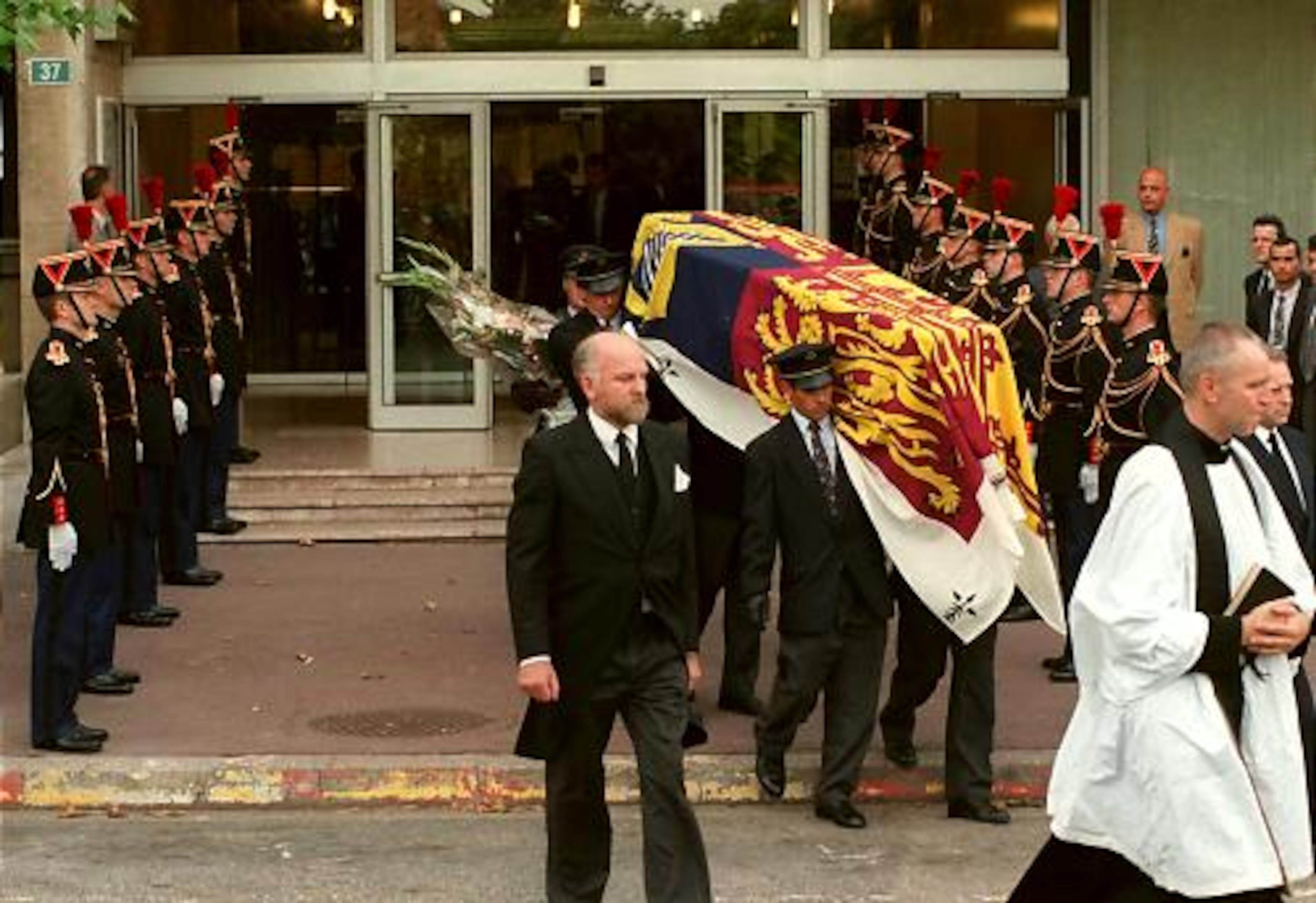 Republican Guards stand at attention as pallbearers carry the coffin of Diana out of a Parisian hospital on Aug. 31, 1997. Diana died in a car crash in the city.