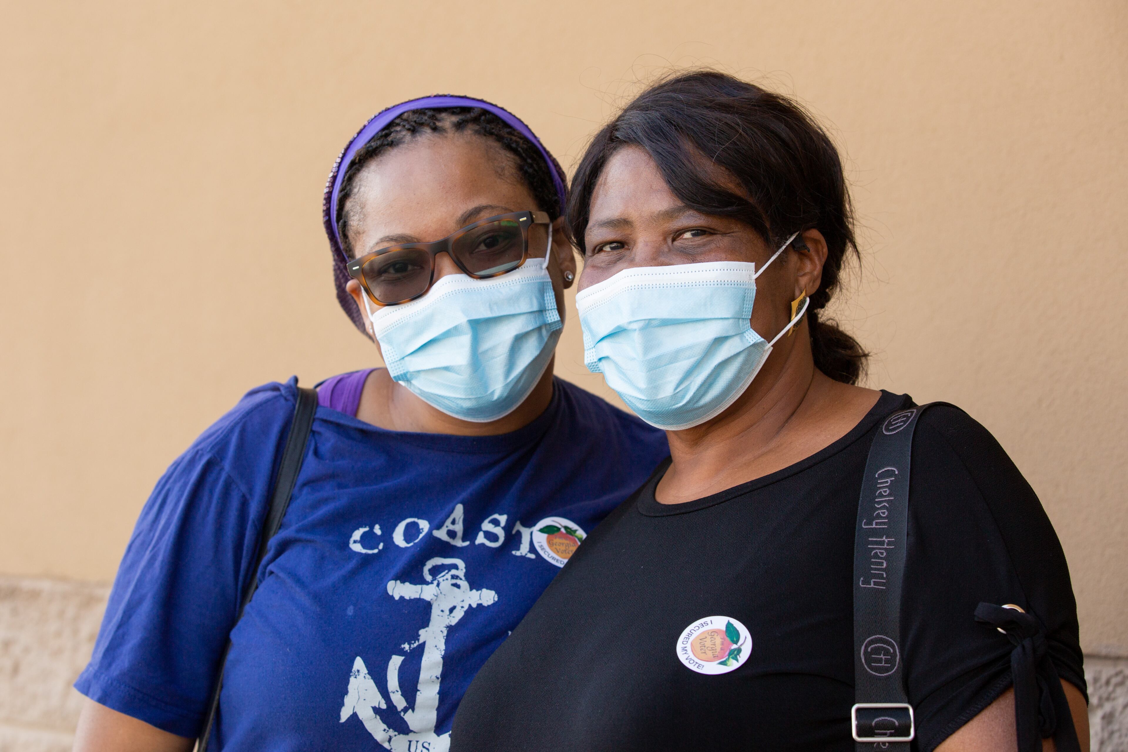 Yentl Butler (left) and her mother, Murdeline McCalla, pose for a photo after voting at the future Stonecrest City Hall in Stonecrest, Georgia, on Saturday, October 24, 2020. (Rebecca Wright for The Atlanta Journal-Constitution)