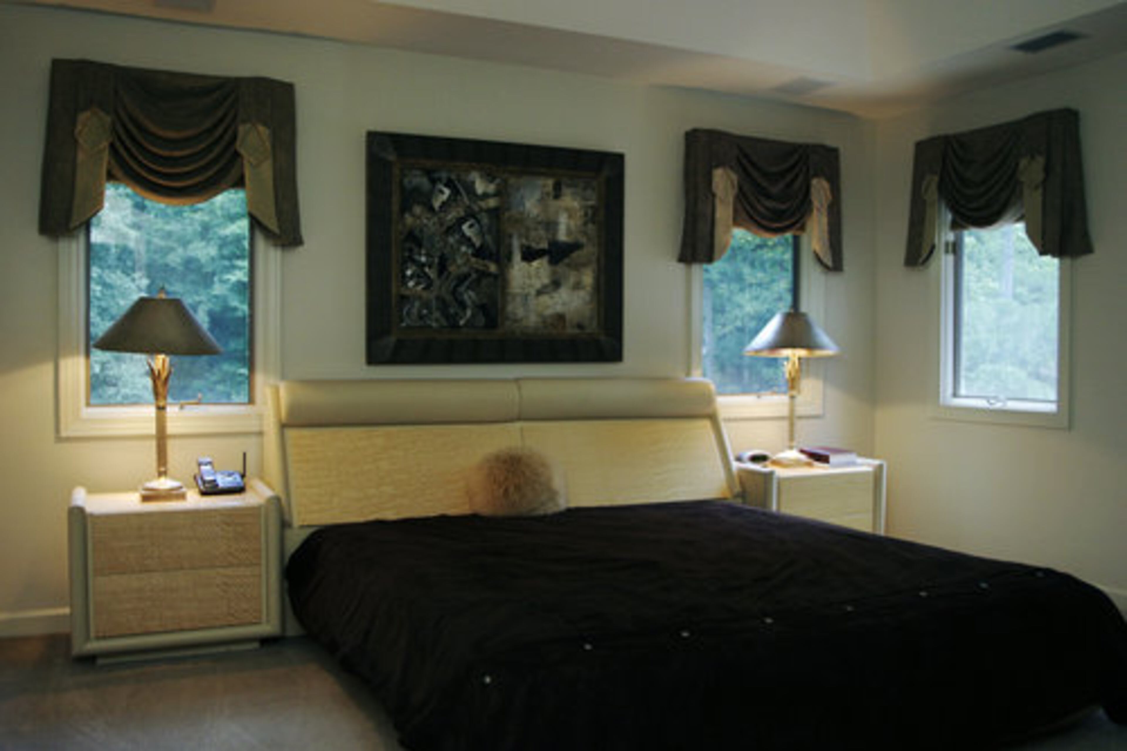 This is the master suite. The rooms upstairs have a soft contemporary feel, thanks to Julie Huff. "Jimmy gets the first floor. He's a bit more contemporary than me," she said. "I like the curves." She did have another beautiful artwork hanging in the bedroom until she discovered it would look better in the home of a client. "... So many of our clients want everything now."