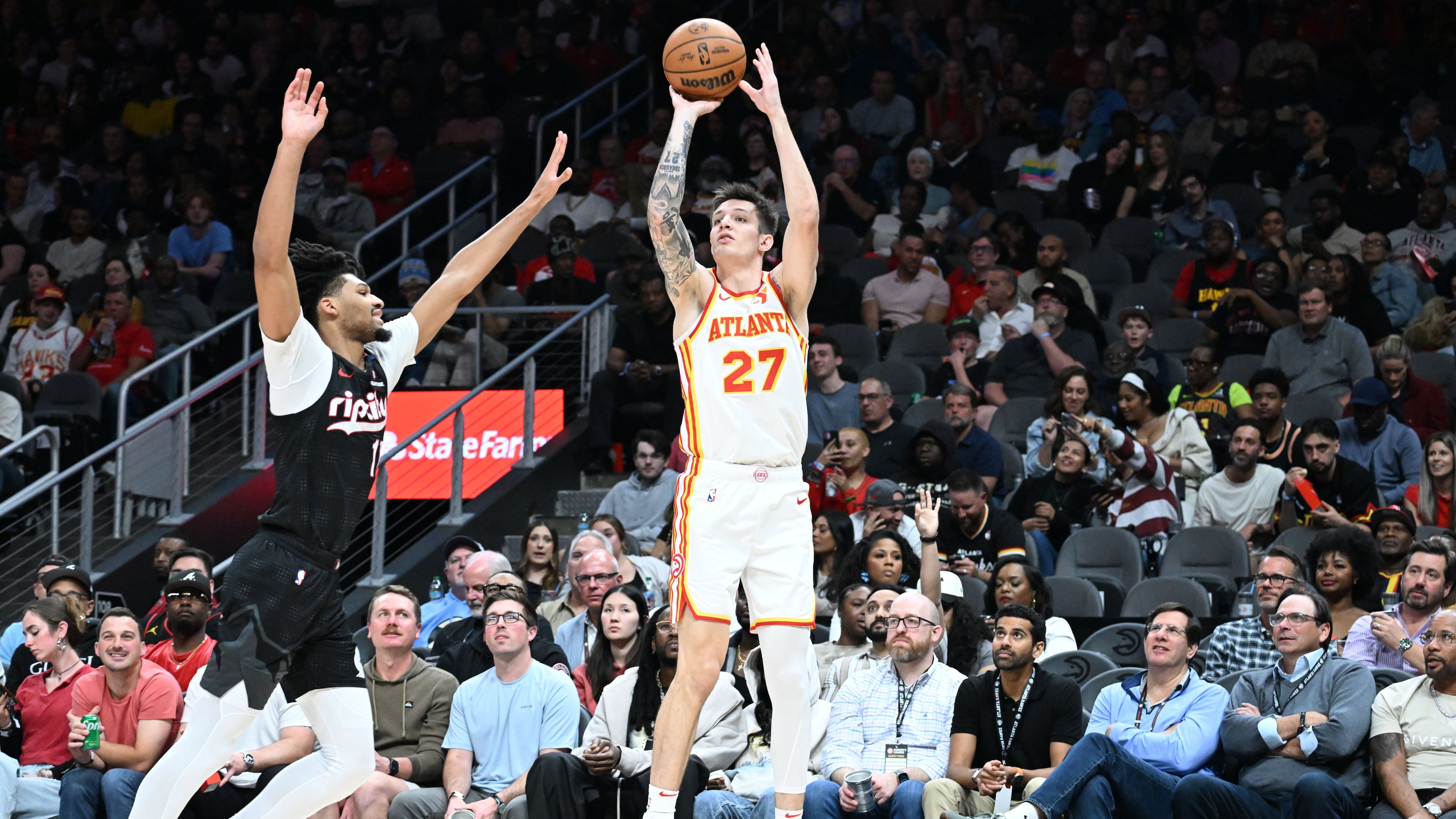 The Hawks traded Vit Krejci (right) — pictured shooting against Portland's Shaedon Sharpe in April — to the Trail Blazers for Duop Reath and two second-round draft picks. (Hyosub Shin/AJC 2025)