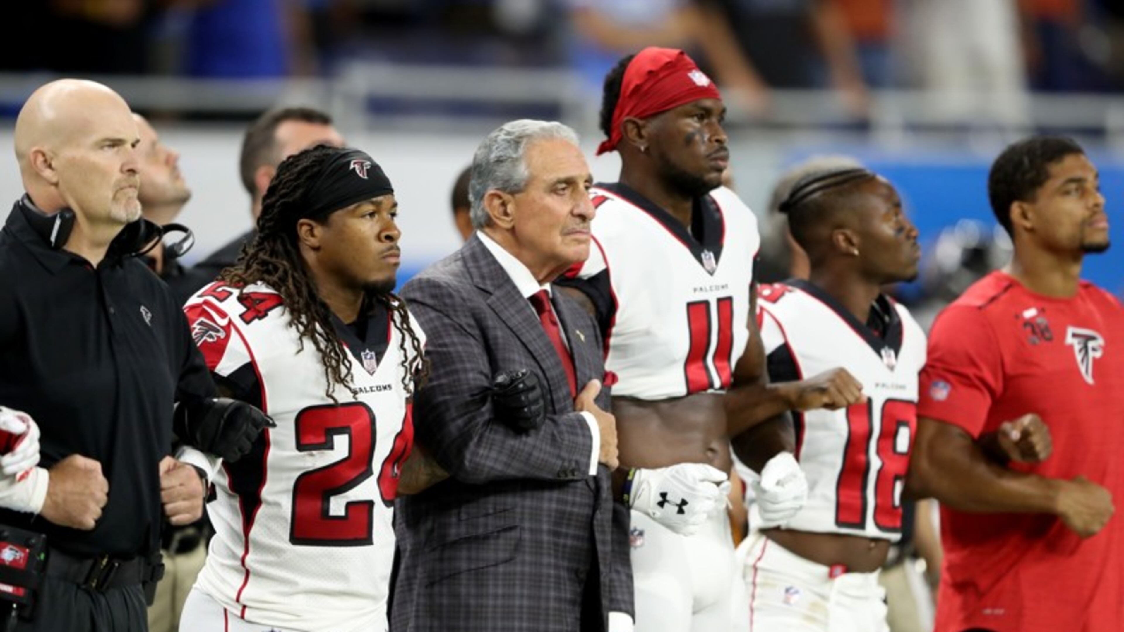 Atlanta Falcons owner Arthur Blank joins arms with his players during the playing of the national anthem prior to the game against the Detroit Lions at Ford Field earlier this season. Leon Halip/Getty Images
