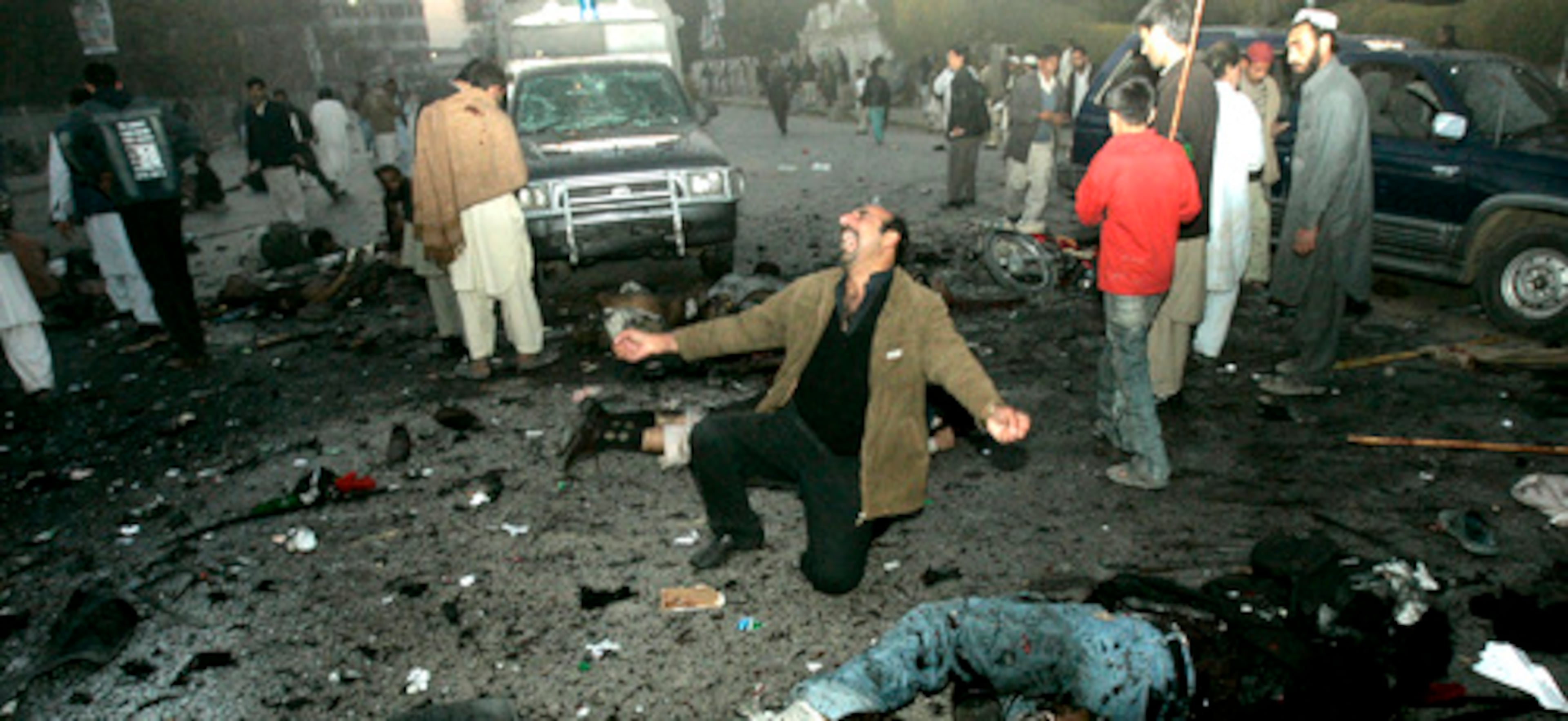 A supporter of Pakistan former Prime Minister Benazir Bhutto mourns deaths of his colleagues Thursday.