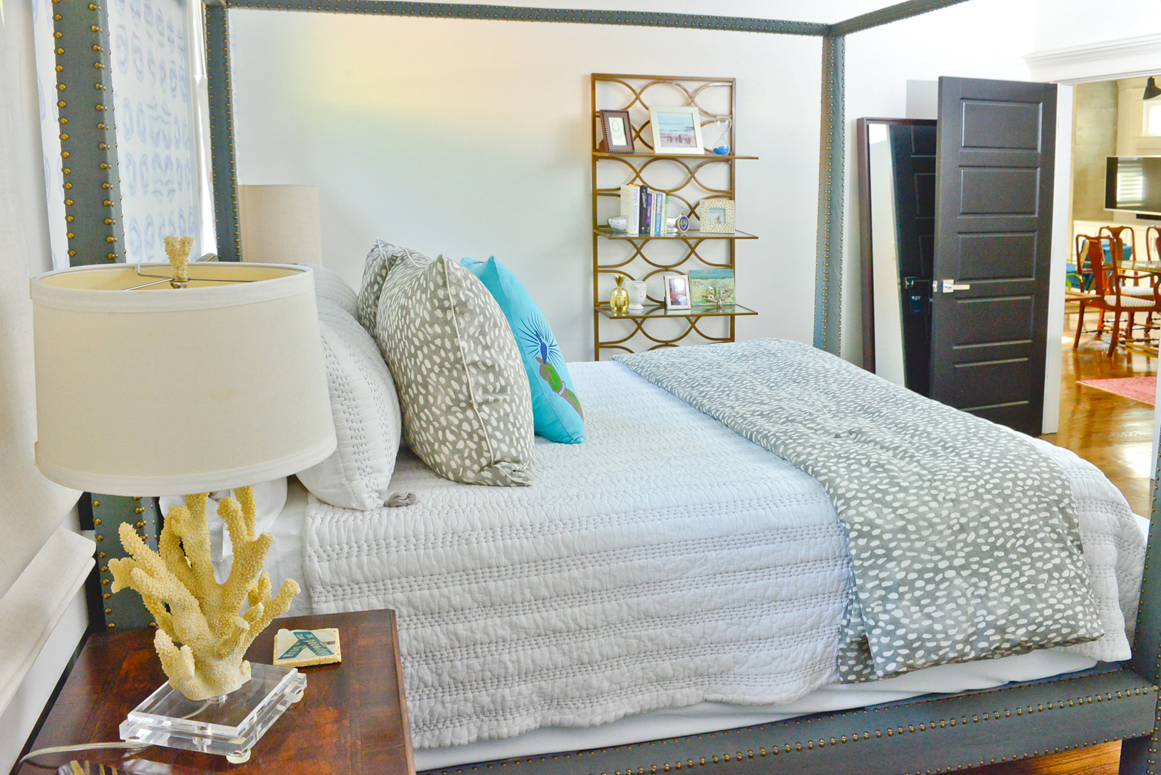 The lamp on the bedside table in Grace's master bedroom pulls in the ocean feel. The base strongly resembles coral, adding to the beach vibe.