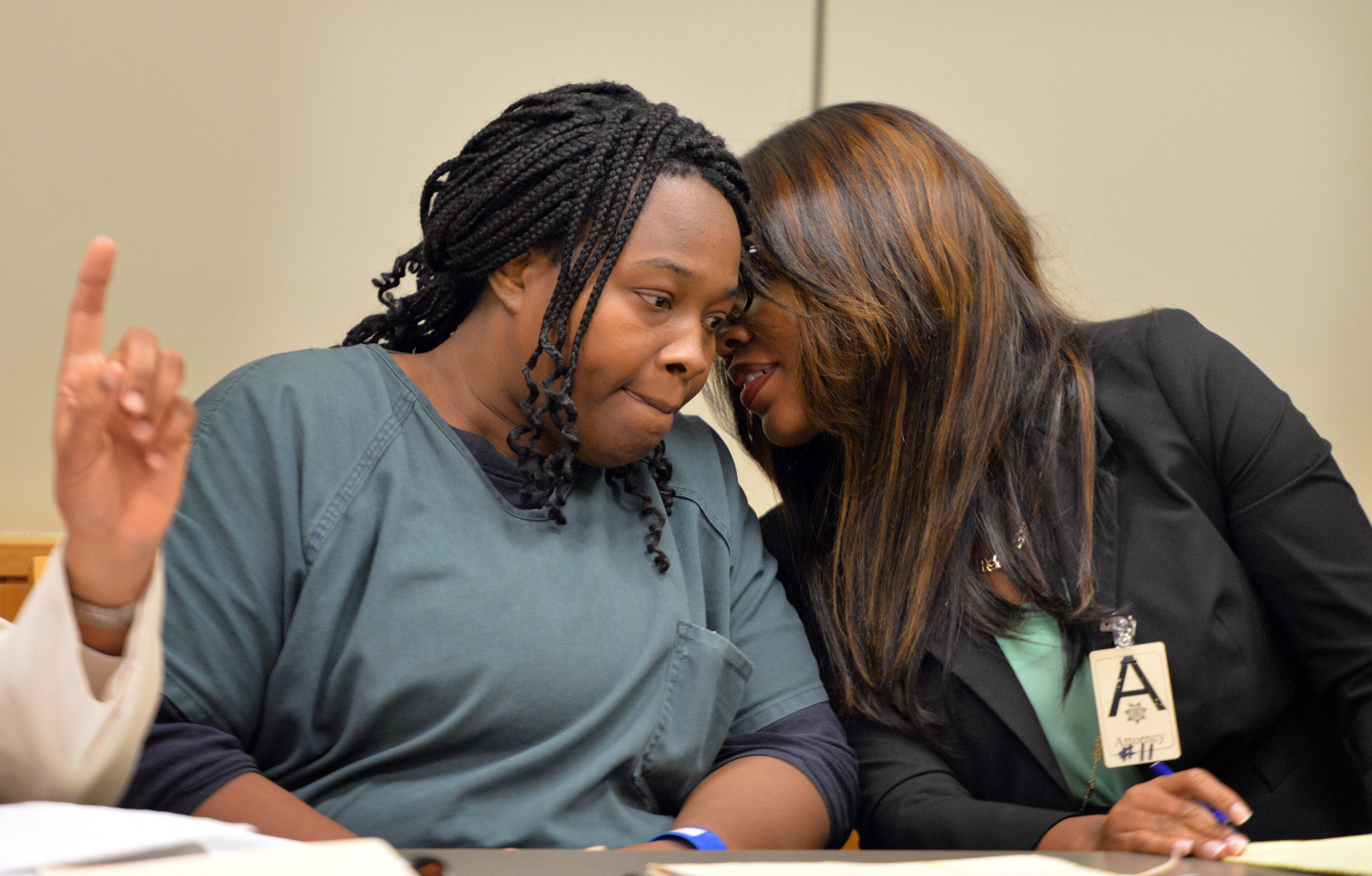 July 10, 2014 Lawrenceville - Therian Wimbushat (left) confers with her defense attorney Otanya Clarke during a hearing before Gwinnett chief magistrate Christina Blum at Gwinnett Magistrate Court in Lawrenceville on Thursday, July 10, 2014. Bond has been denied for Recardo and Therian Wimbush being held on child cruelty charges that they kept their oldest child a prisoner in their home. HYOSUB SHIN / HSHIN@AJC.COM