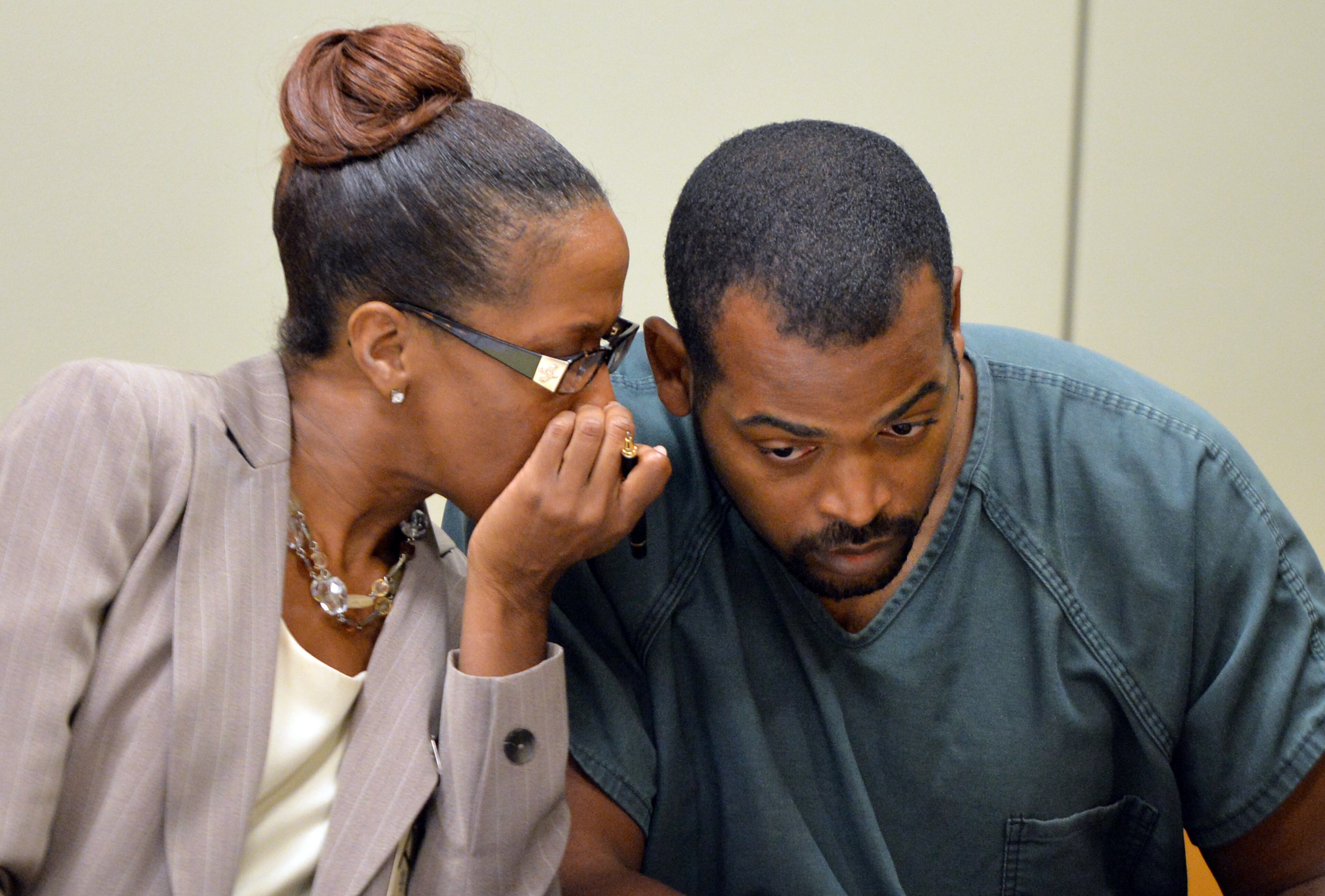 July 10, 2014 Lawrenceville - Recardo Wimbushat (right) confers with his defense attorney Teri Thompson during a hearing before Gwinnett chief magistrate Christina Blum at Gwinnett Magistrate Court in Lawrenceville on Thursday, July 10, 2014. Bond has been denied for Recardo and Therian Wimbush being held on child cruelty charges that they kept their oldest child a prisoner in their home. HYOSUB SHIN / HSHIN@AJC.COM
