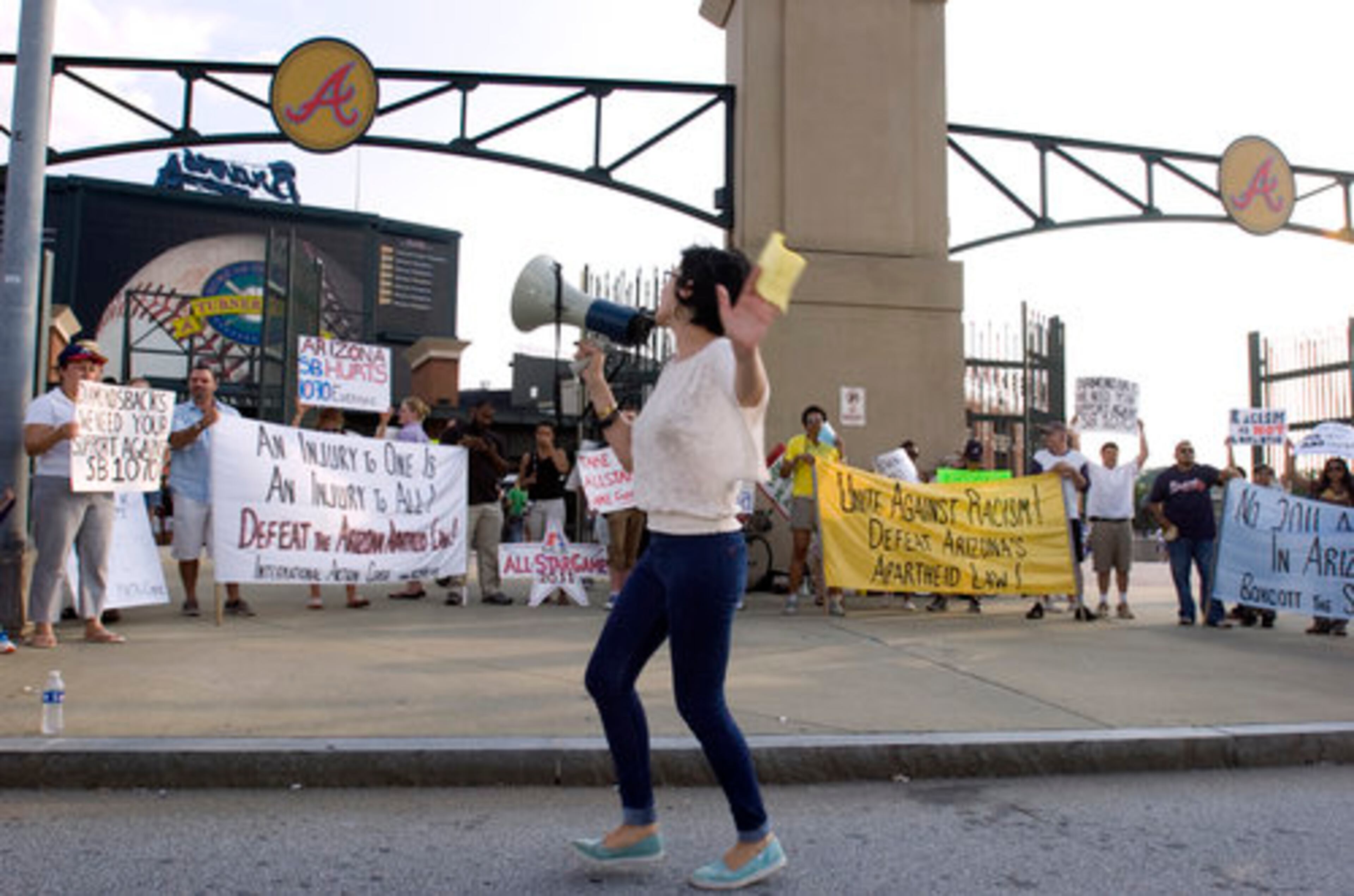 Vanessa Farag of Atlanta leads the rally. She said the group is not protesting the ball players at Turner Field, but the state of Arizona's action.