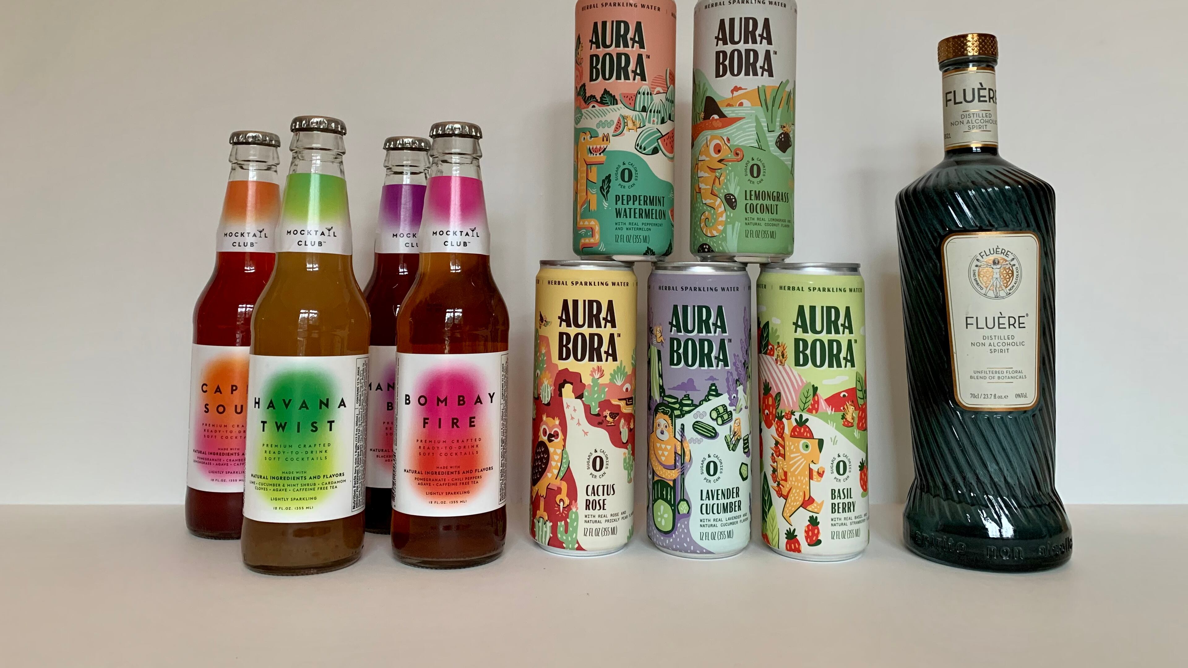 Mocktail Club's bottled drinks, Aura Bora cans of sparkling water and Fluére's distilled spirit are three nonalcoholic options to add to your home bar. Angela Hansberger for The Atlanta Journal-Constitution