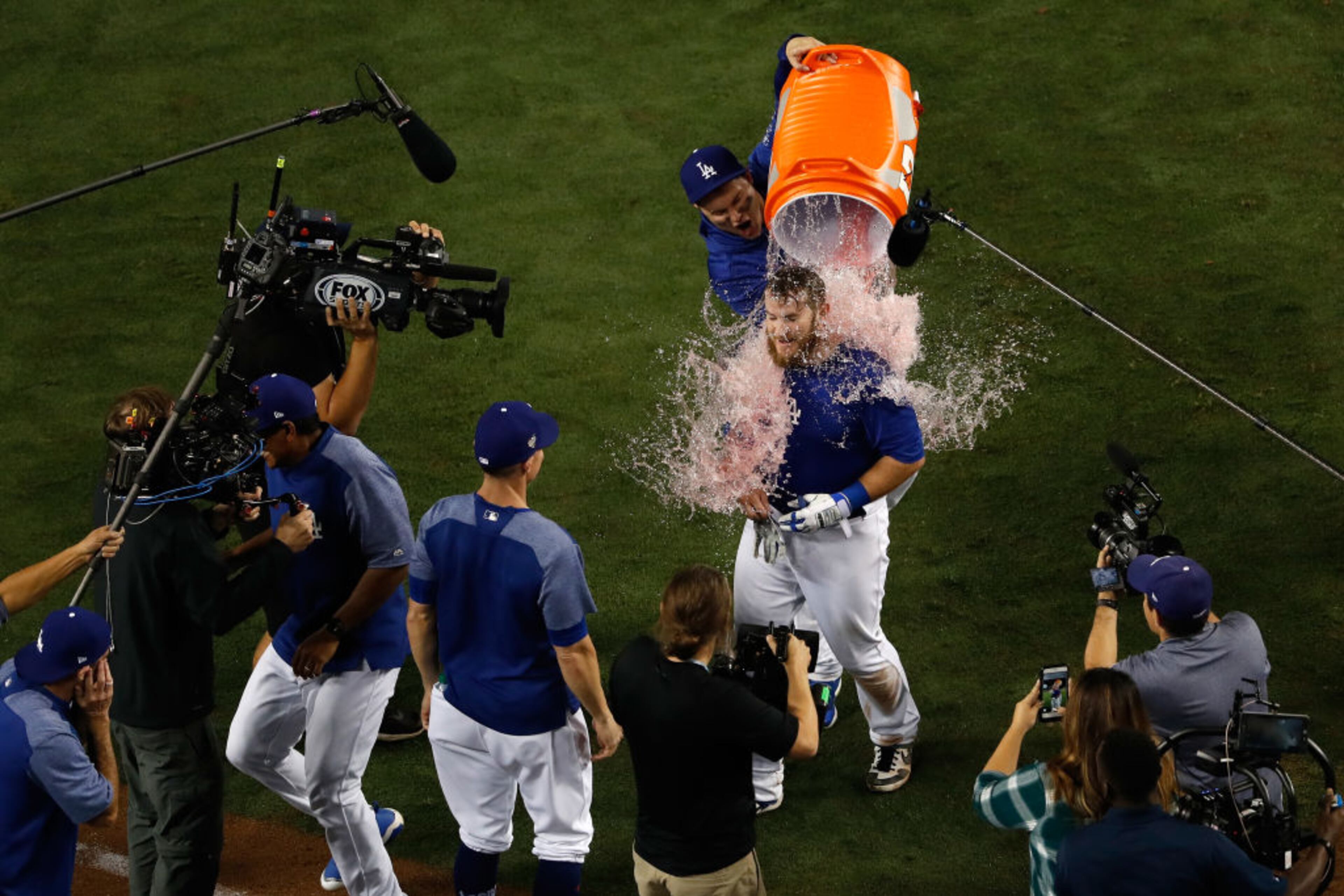 LOS ANGELES, CA - OCTOBER 26: Max Muncy #13 of the Los Angeles Dodgers is given a gatorade bath after hitting his eighteenth inning walk-off home run to defeat the Boston Red Sox 3-2 in Game Three of the 2018 World Series at Dodger Stadium on October 26, 2018 in Los Angeles, California. (Photo by Sean M. Haffey/Getty Images)