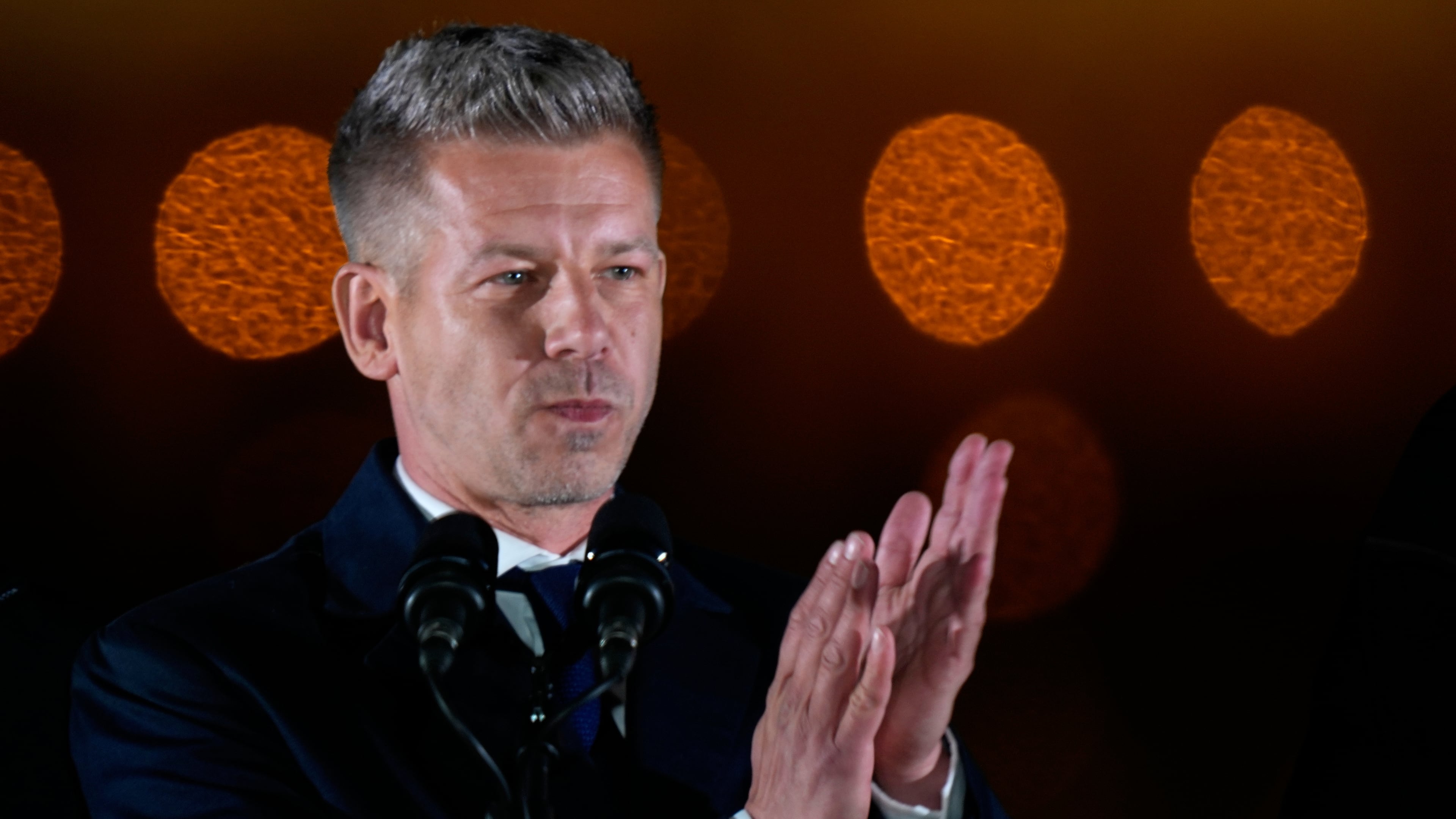 Peter Magyar, the leader of the opposition Tisza party applauds after claiming victory in a parliamentary election in Budapest, Hungary, Sunday, April 12, 2026. (AP Photo/Darko Bandic)