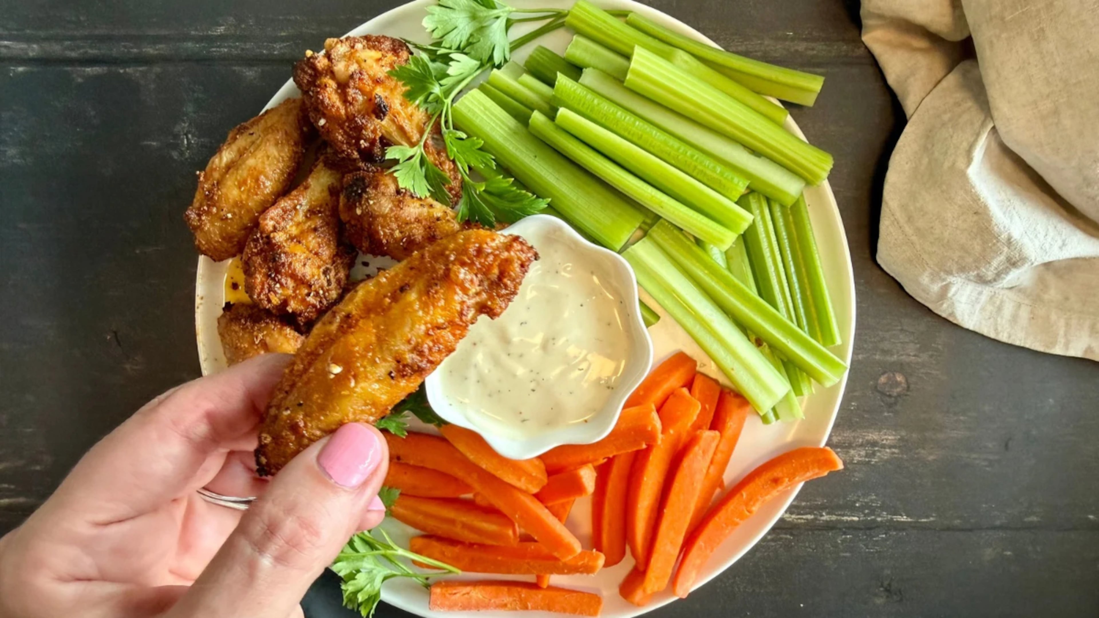 Cornstarch, baking powder, and a two-temperature method give these lemon-pepper wet wings crisp, deeply browned skin without frying.