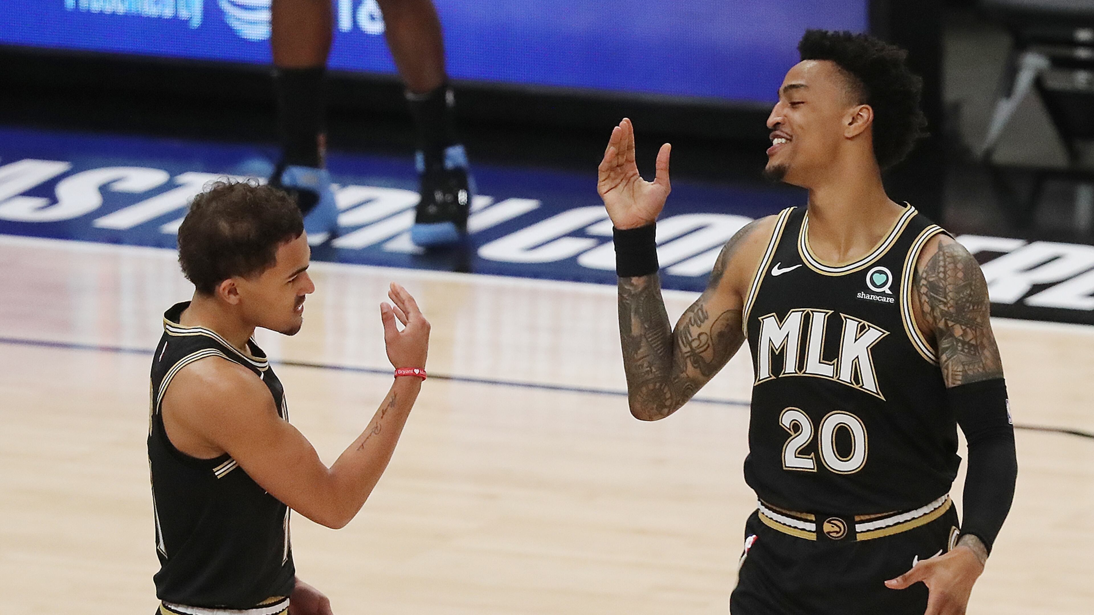 Atlanta Hawks guard Trae Young and forward John Collins get together to begin the game against the Milwaukee Bucks in Game 6 of the NBA Eastern Conference Finals on Saturday, July 3, 2021, in Atlanta. “Curtis Compton / Curtis.Compton@ajc.com”