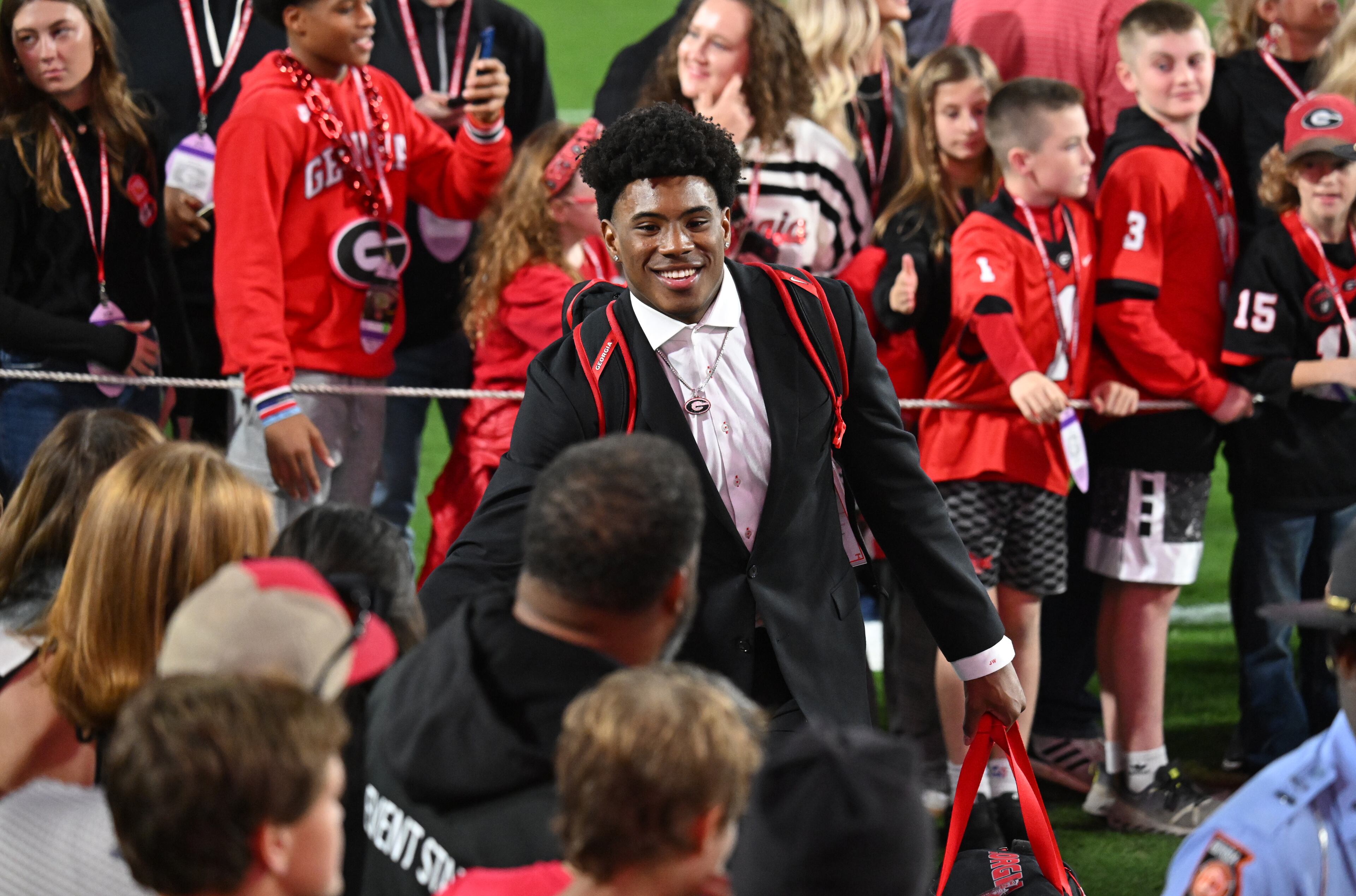 Georgia linebacker Justin Williams (19) greets fans as he enters with teammates and coaching staff during Dawgs Walk before an NCAA football game between Georgia and Tennessee at Sanford Stadium, Saturday, November 16, 2024, in Athens. (Hyosub Shin / AJC)