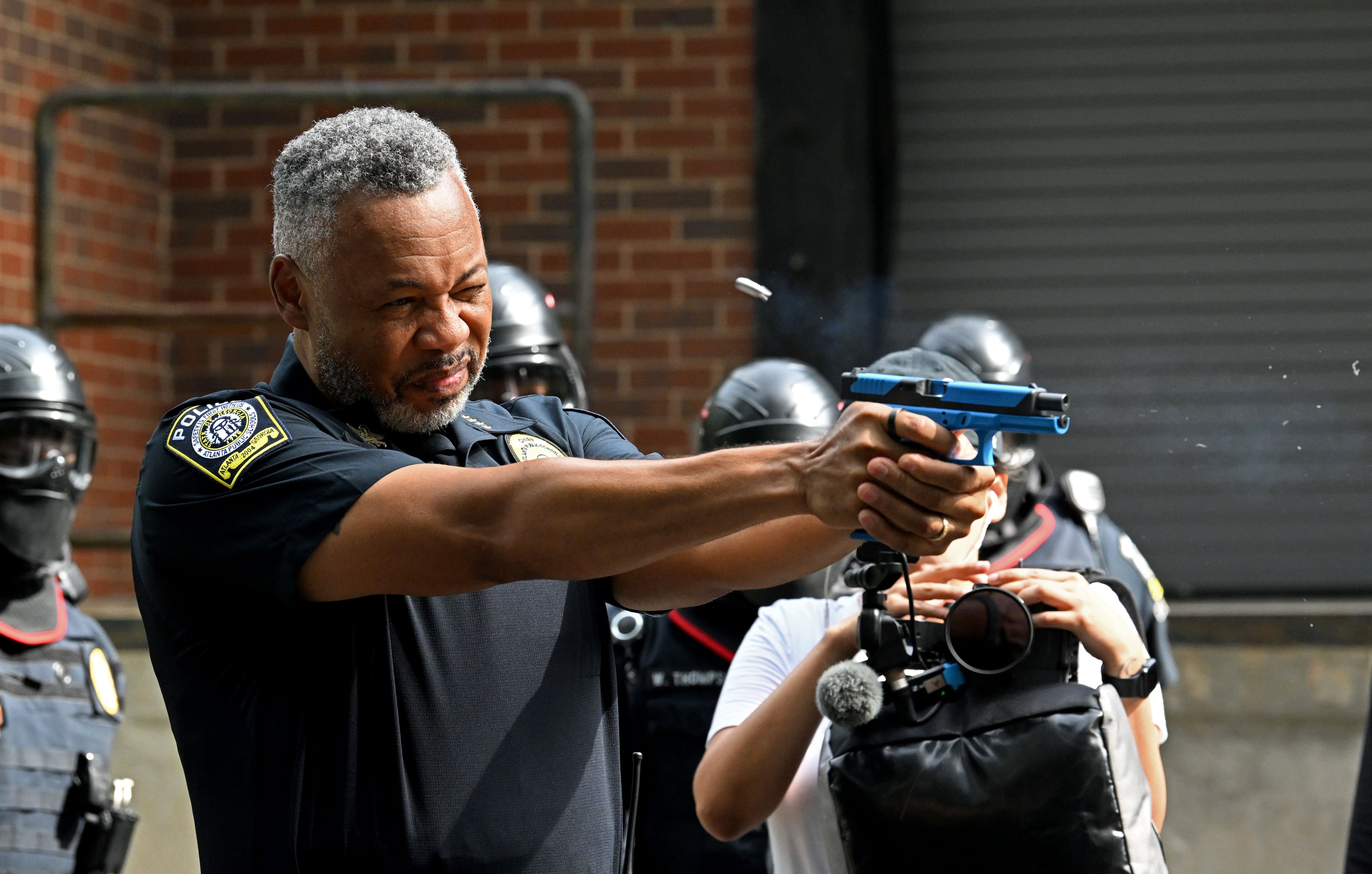 Atlanta Public Schools (APS) Police Chief Ronald Applin demonstrates a training handgun during an event introducing two new security units — a tactical team and a drone team — at Atlanta Public Schools’ Brewer Training Center on Tuesday, July 21, 2026, in Atlanta. (Hyosub Shin/AJC)