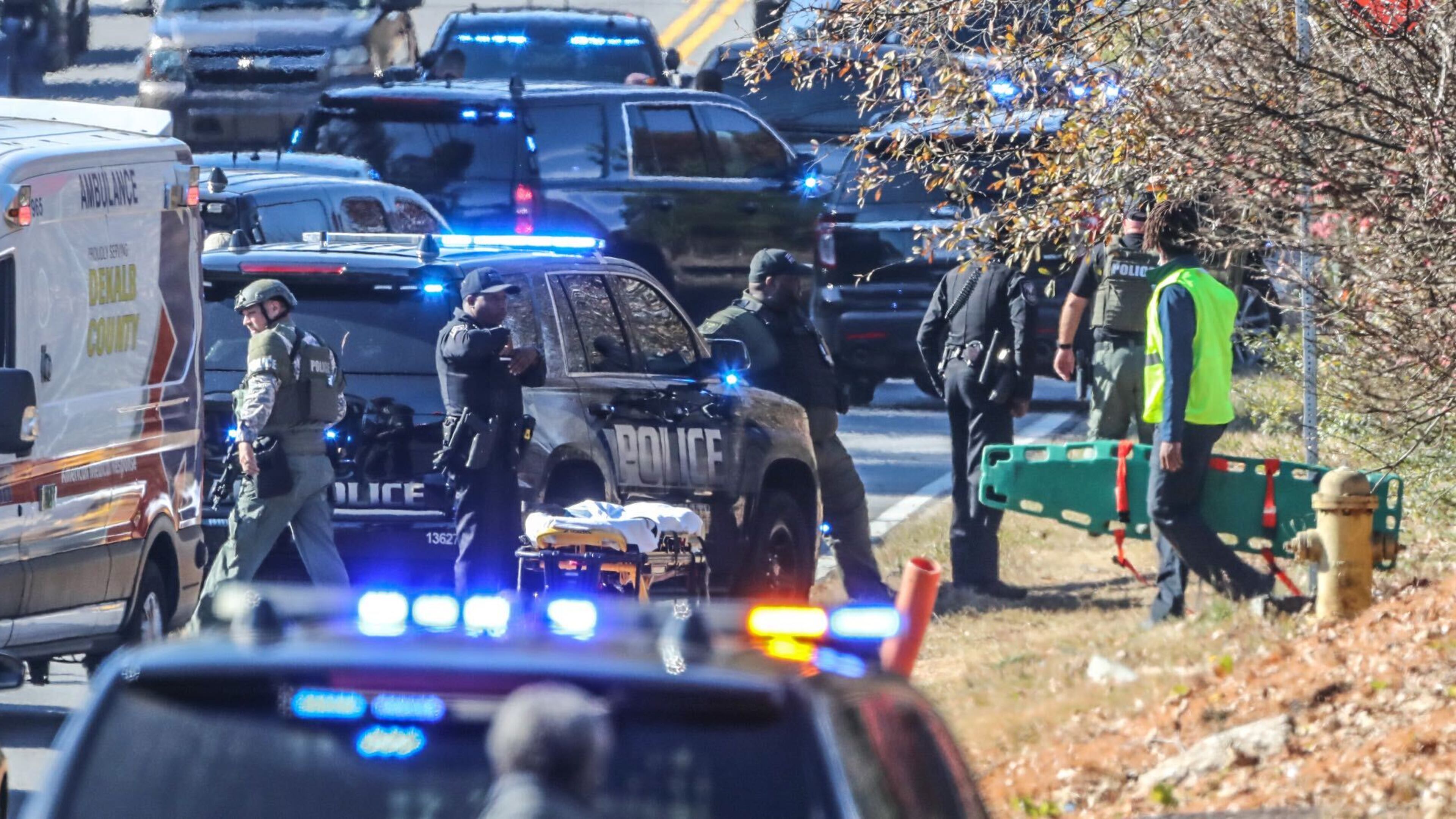 Emergency medical personnel return from the scene where Edward Gatling, the man suspected of shooting two DeKalb County sheriff's investigators, was killed in an exchange of gunfire with officers. (John Spink / john.spink@ajc.com)
