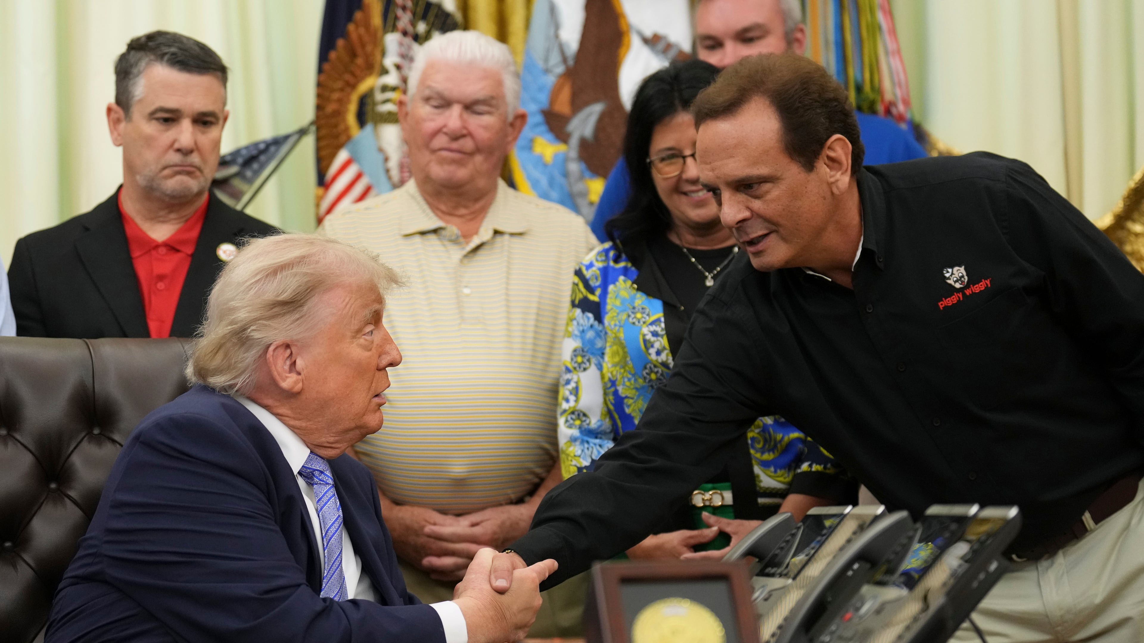 President Donald Trump, left, shakes the hand of Kevin McDaniel, Piggly Wiggly franchise owner, during an event about loosening a federal refrigerant rule, in the Oval Office at the White House, Thursday, May 21, 2026, in Washington. (AP Photo/Jacquelyn Martin)