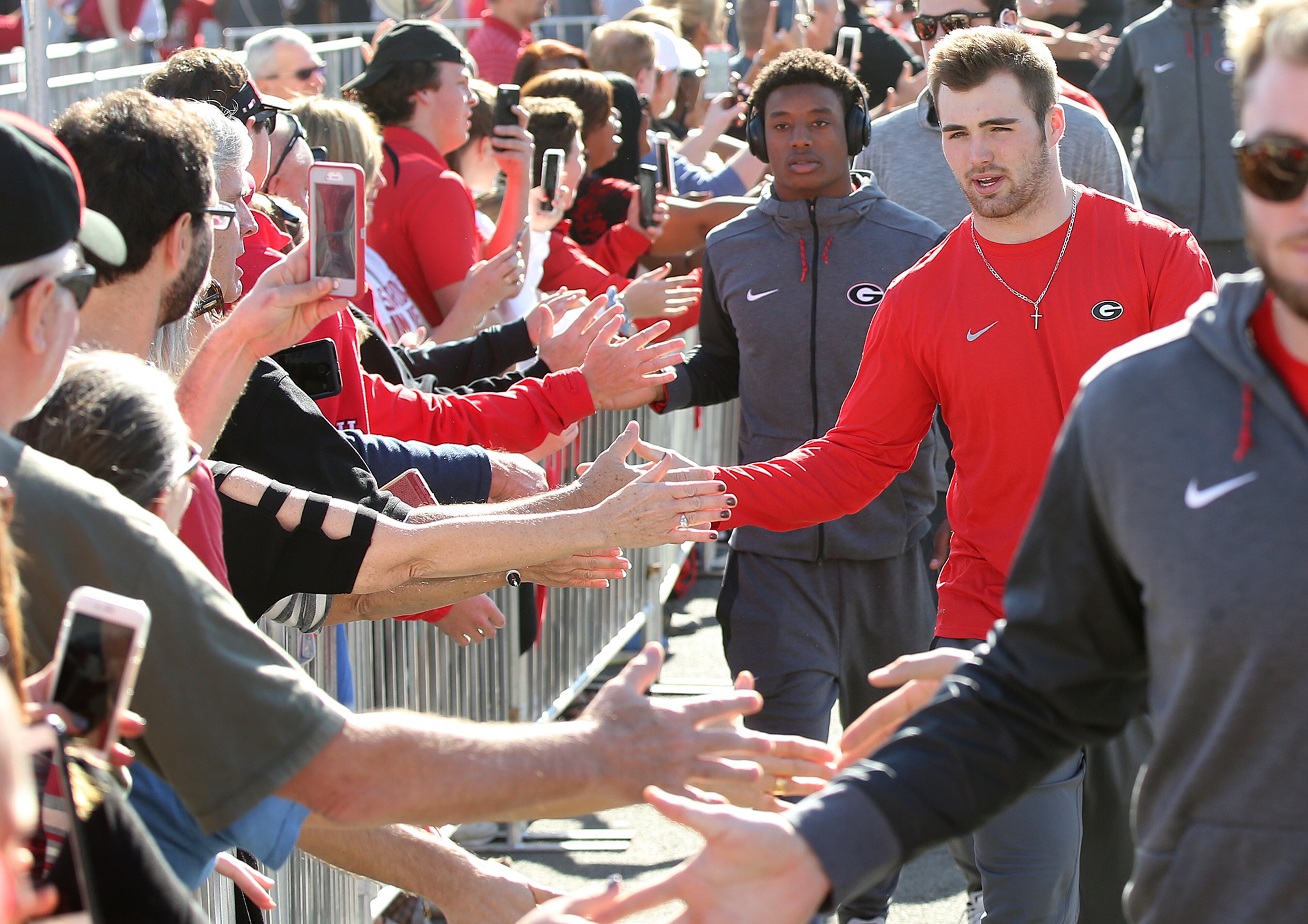 December 31, 2017 Pasadena: Georgia quarterback Jake Fromm gives fans five while arriving for the team photo at Rose Bowl Stadium on Sunday, December 31, 2017, in Pasadena. Curtis Compton/ccompton@ajc.com