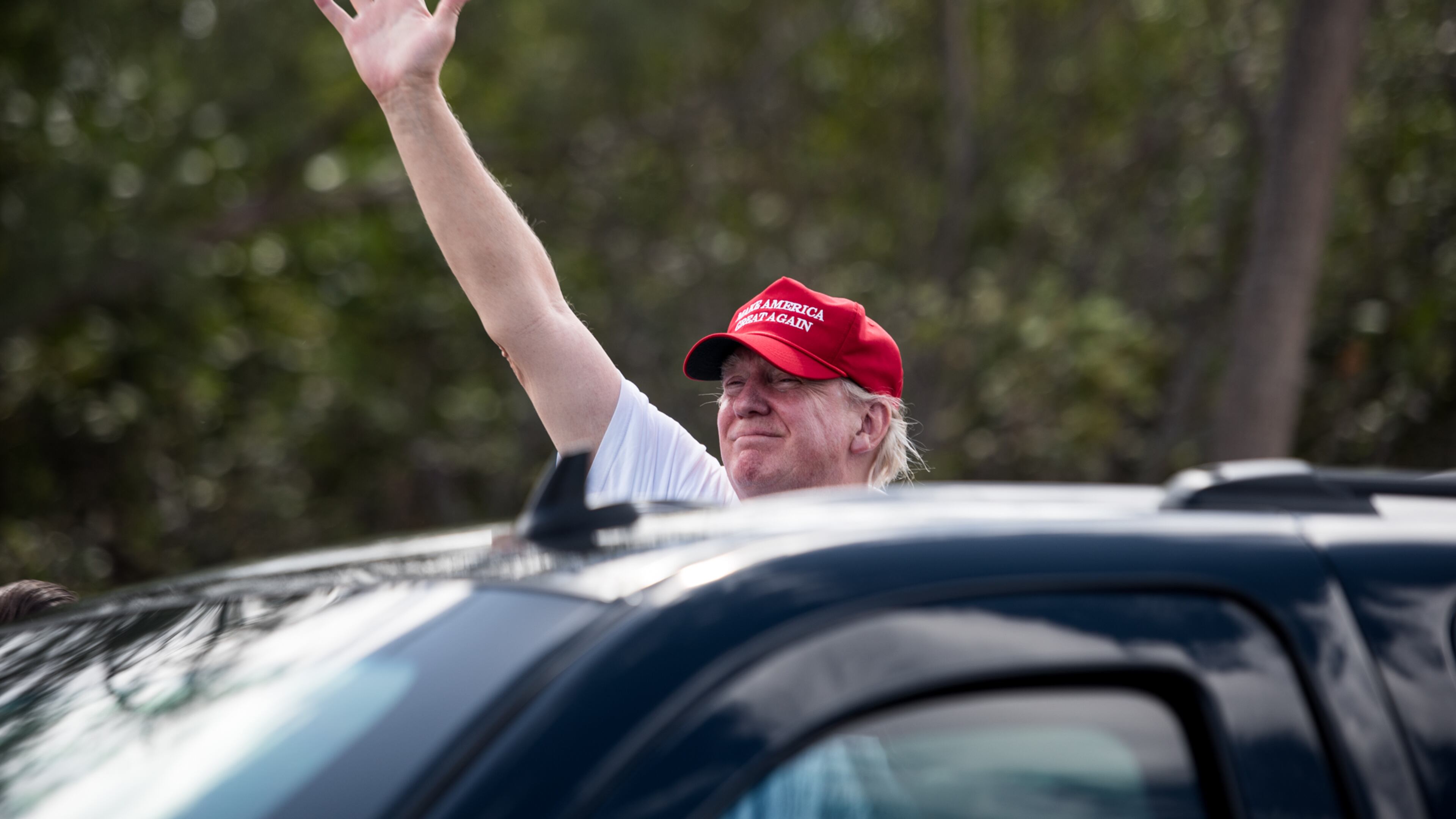 President Donald J. Trump waves to his supporters on Southern Boulevard as his motorcade crosses the Bingham Island Bridge in Palm Beach on Saturday, Mar. 4, 2017. (Michael Ares / The Palm Beach Post)