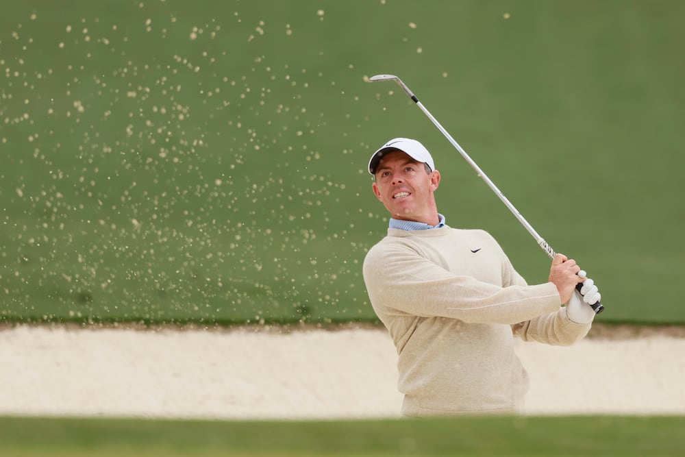 Rory McIlroy hits out of a bunker on the second green during a practice round at the Masters golf tournament on Monday, April 6, 2026, in Augusta. (Jason Getz/AJC)