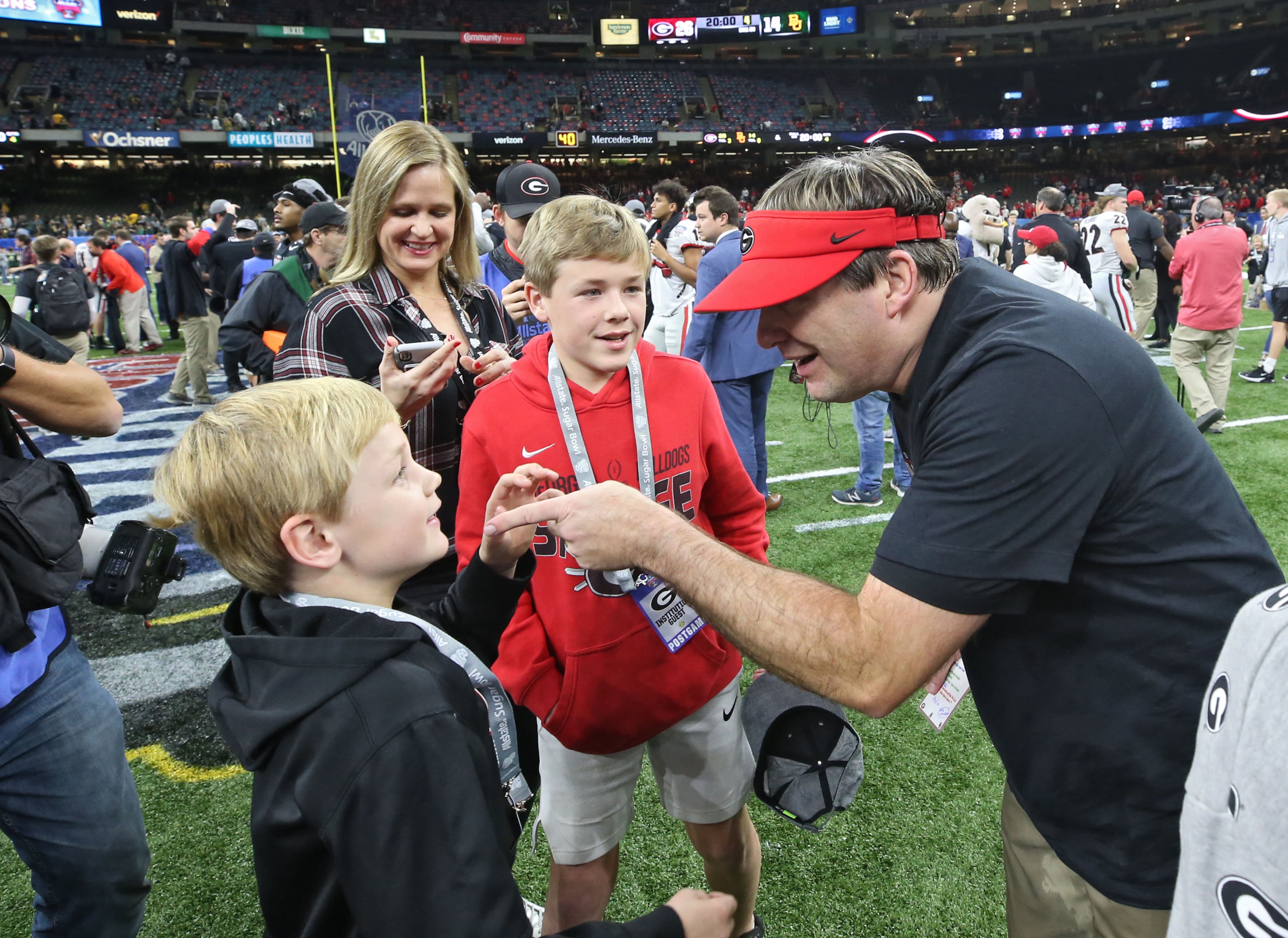 Georgia Bulldogs head coach Kirby Smart celebrates with his children, including Andrew (left) and Weston. Bob Andres bandres@ajc.com
