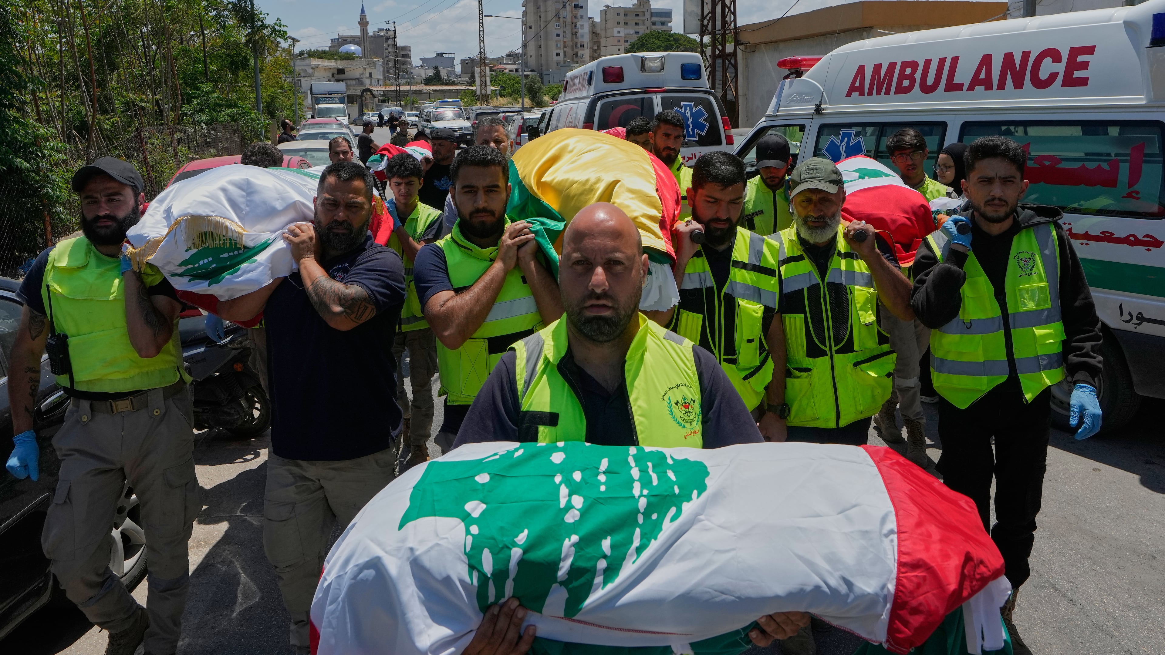 Mourners and paramedics carry the bodies of family members killed on Wednesday when their car was struck in an Israeli airstrike on a highway as they fled their village, during a funeral procession in the southern port city of Tyre, Lebanon, Friday, May 29, 2026. (AP Photo/Mohammed Zaatari)